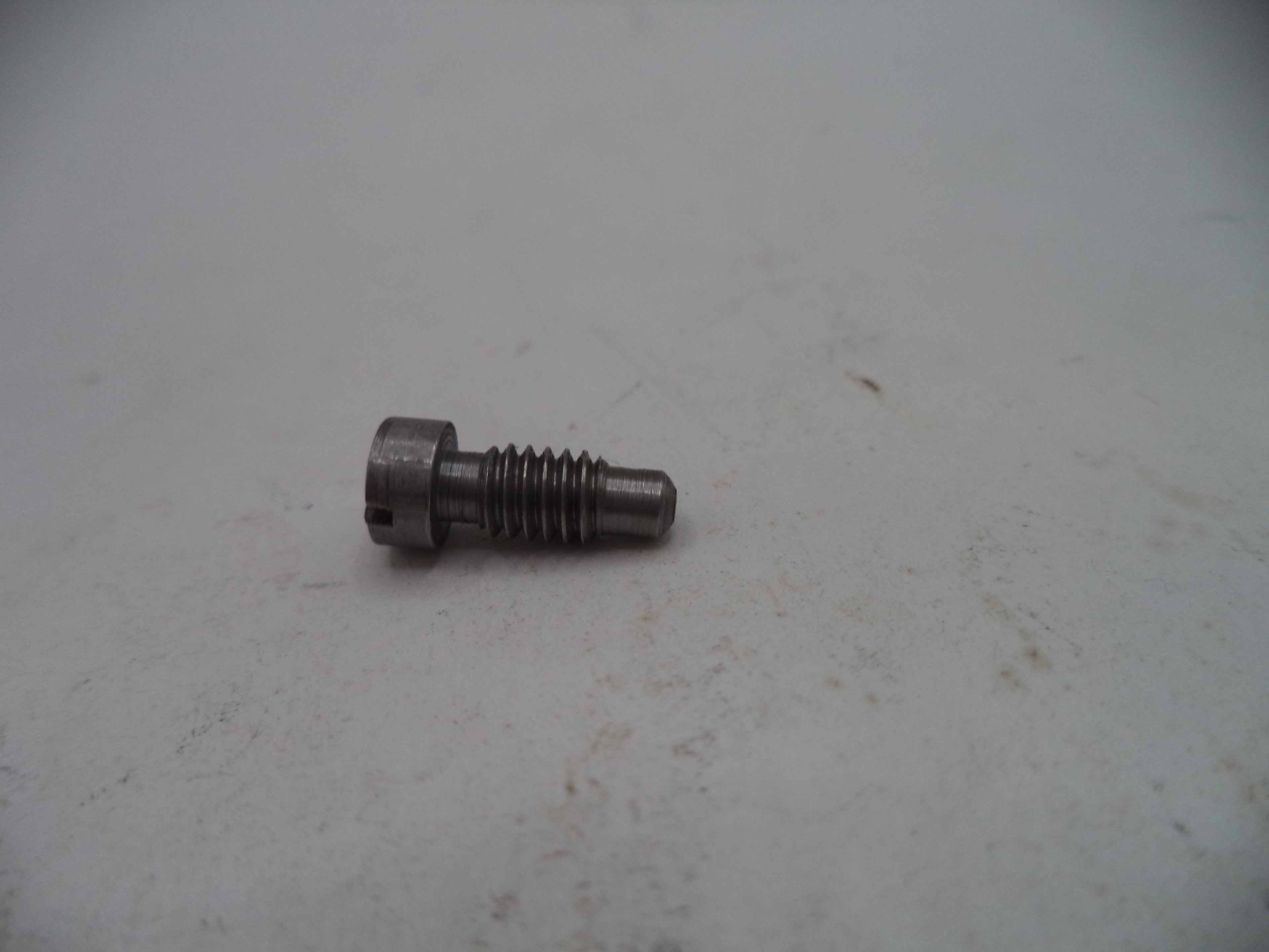 Metal screw on a light gray surface