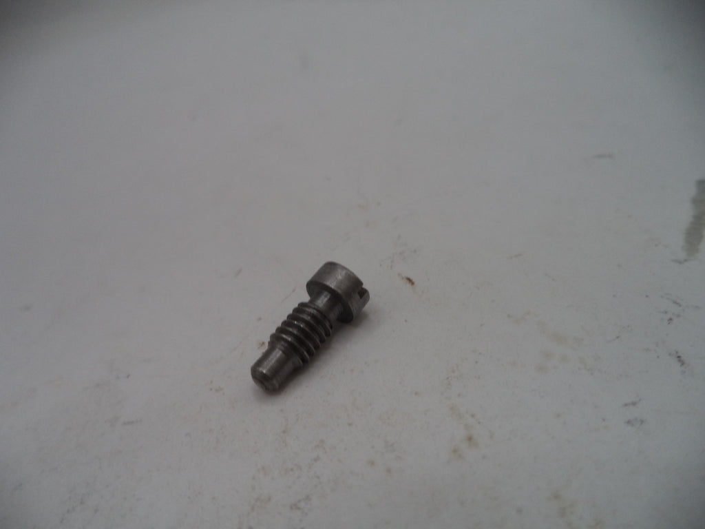 Metal screw on a textured white surface