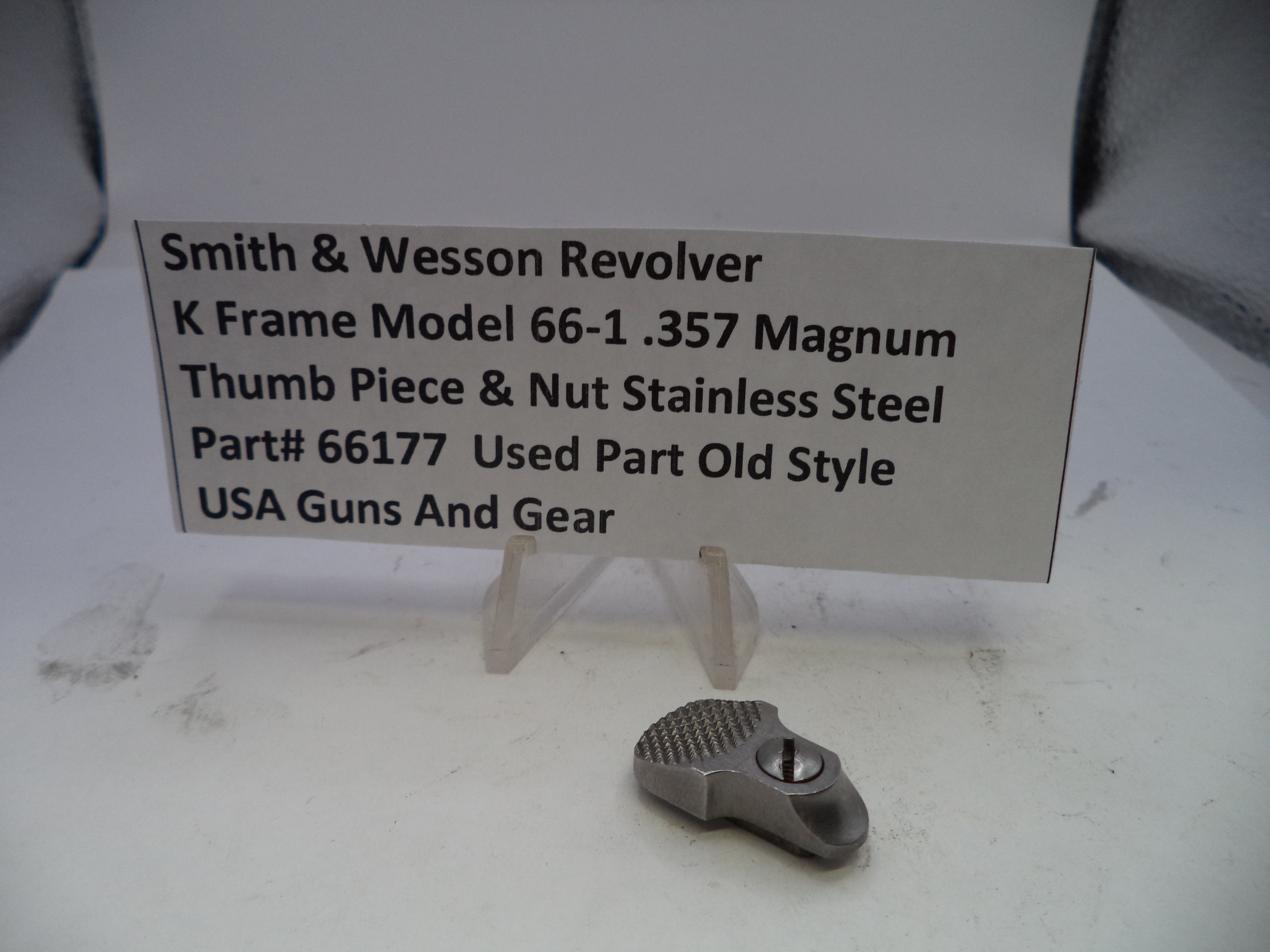 Smith & Wesson revolver part with descriptive card on a white background
