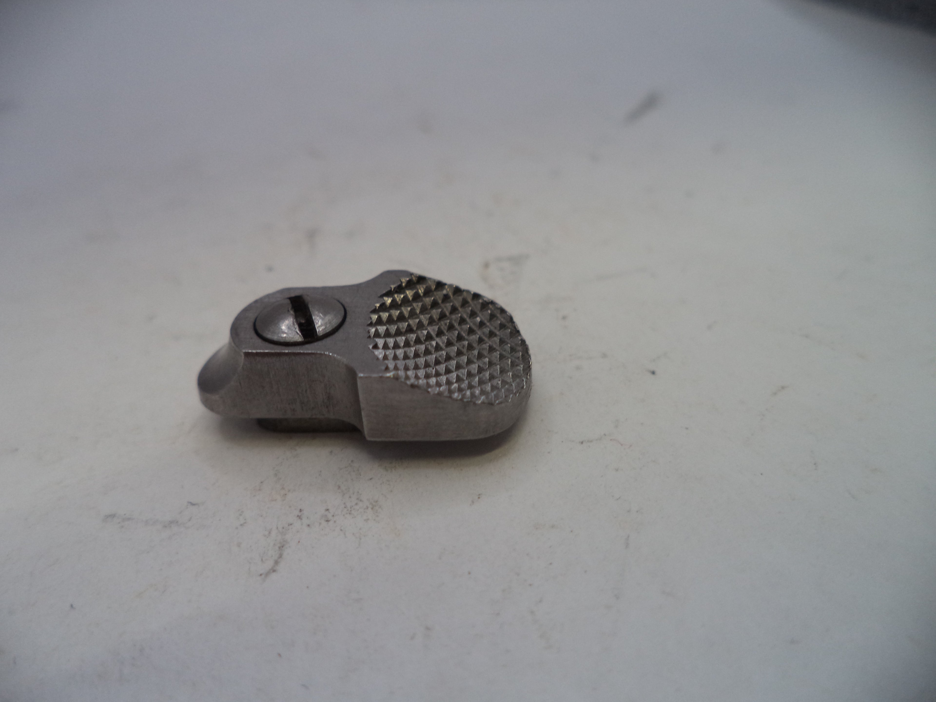 Metallic object with textured surface on a white background