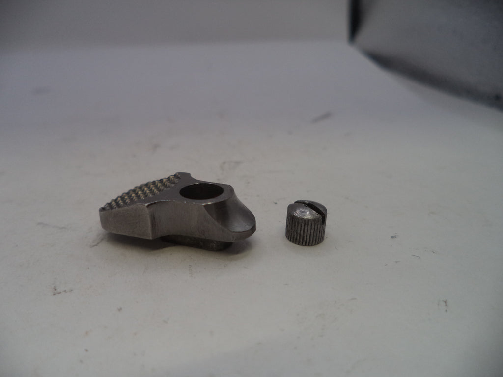 Two metal components on a white surface