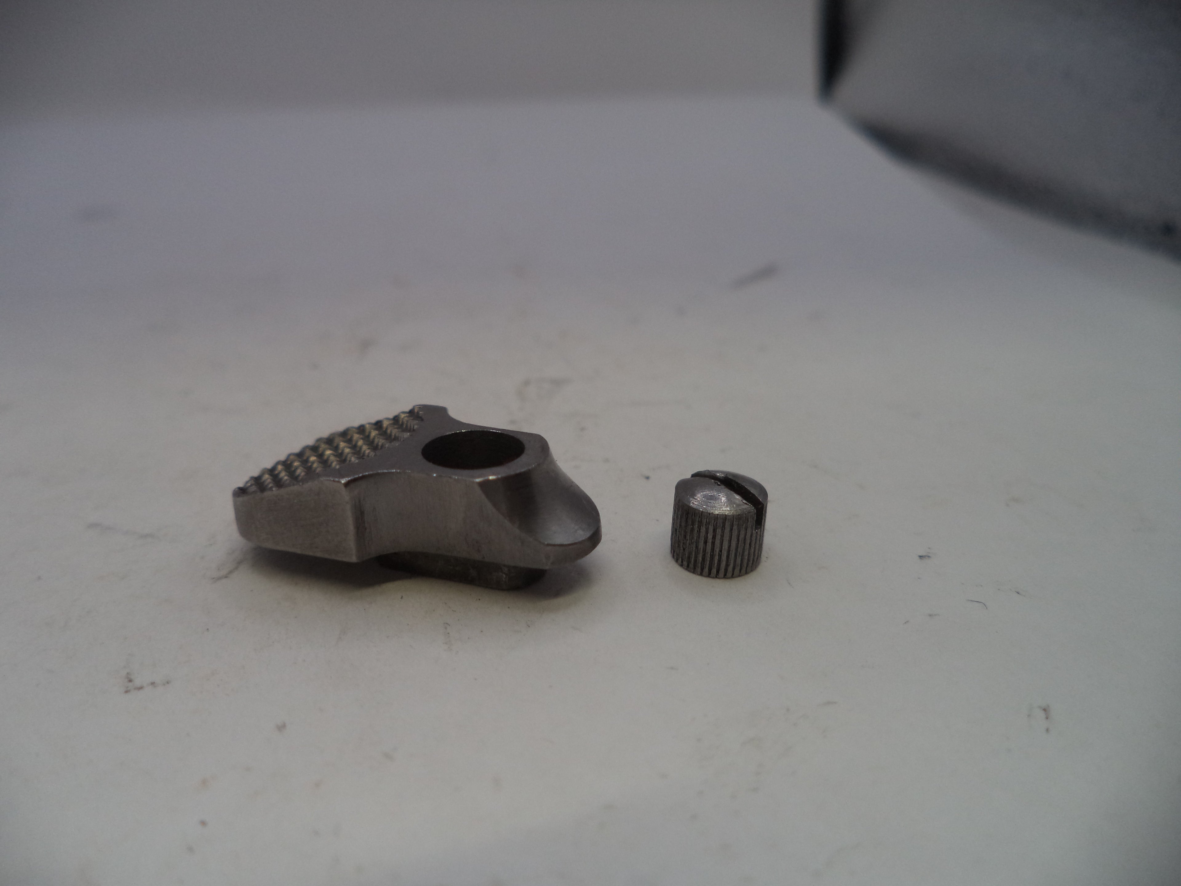 Two metal components on a white surface