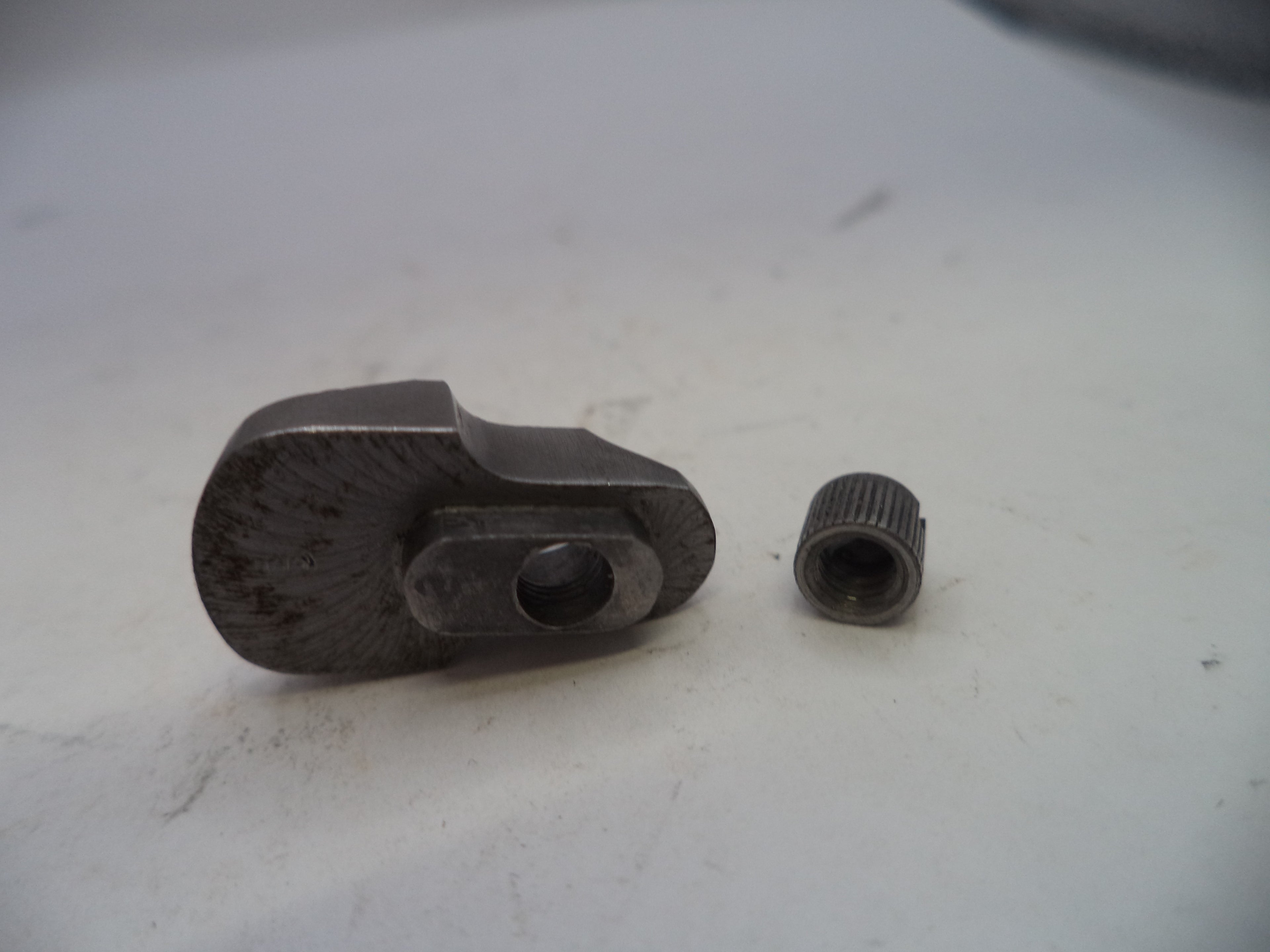 Two metal components on a white surface