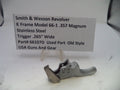 Smith & Wesson revolver trigger part with descriptive label on a white background