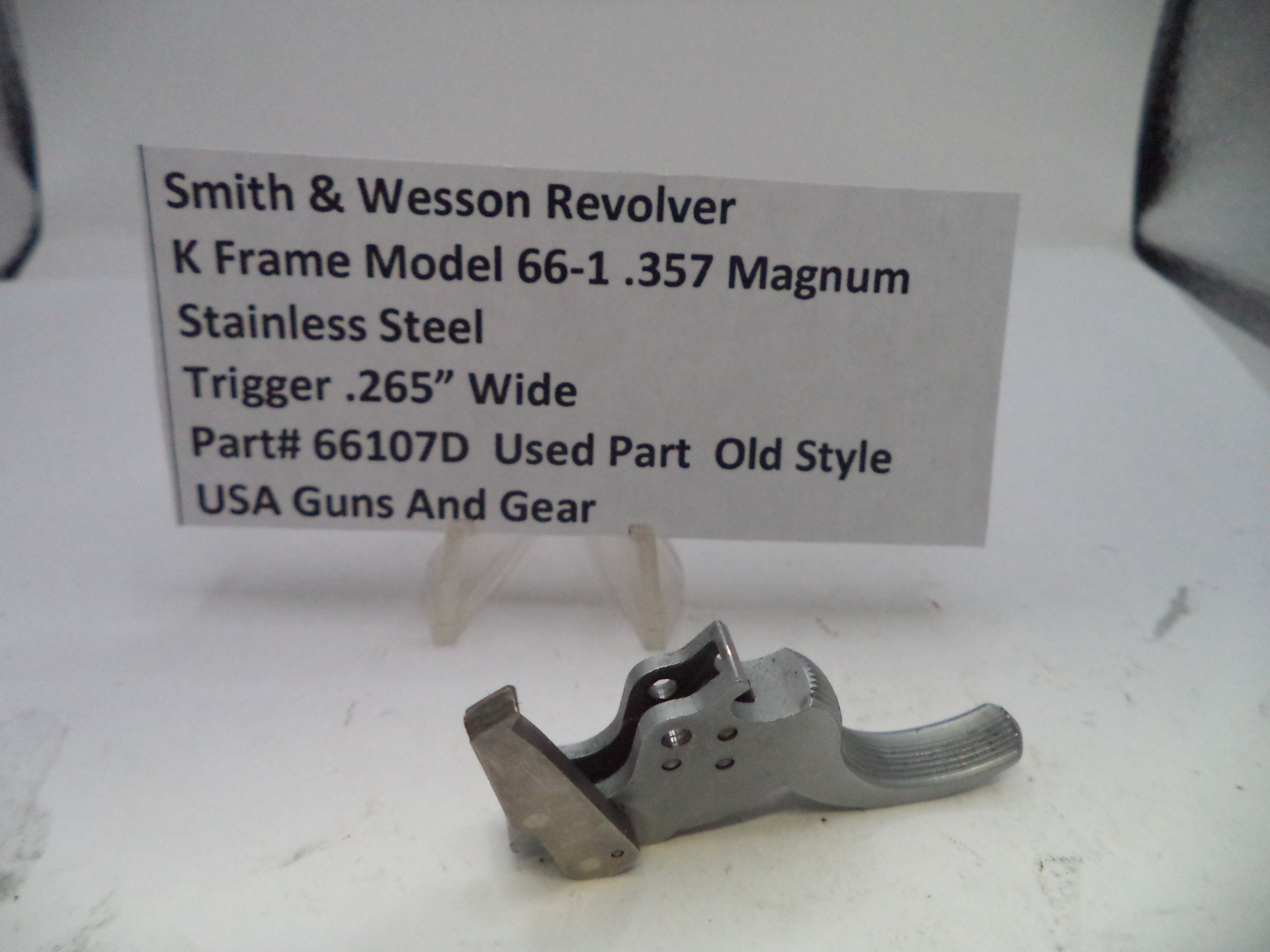 Smith & Wesson revolver trigger part with descriptive label on a white background