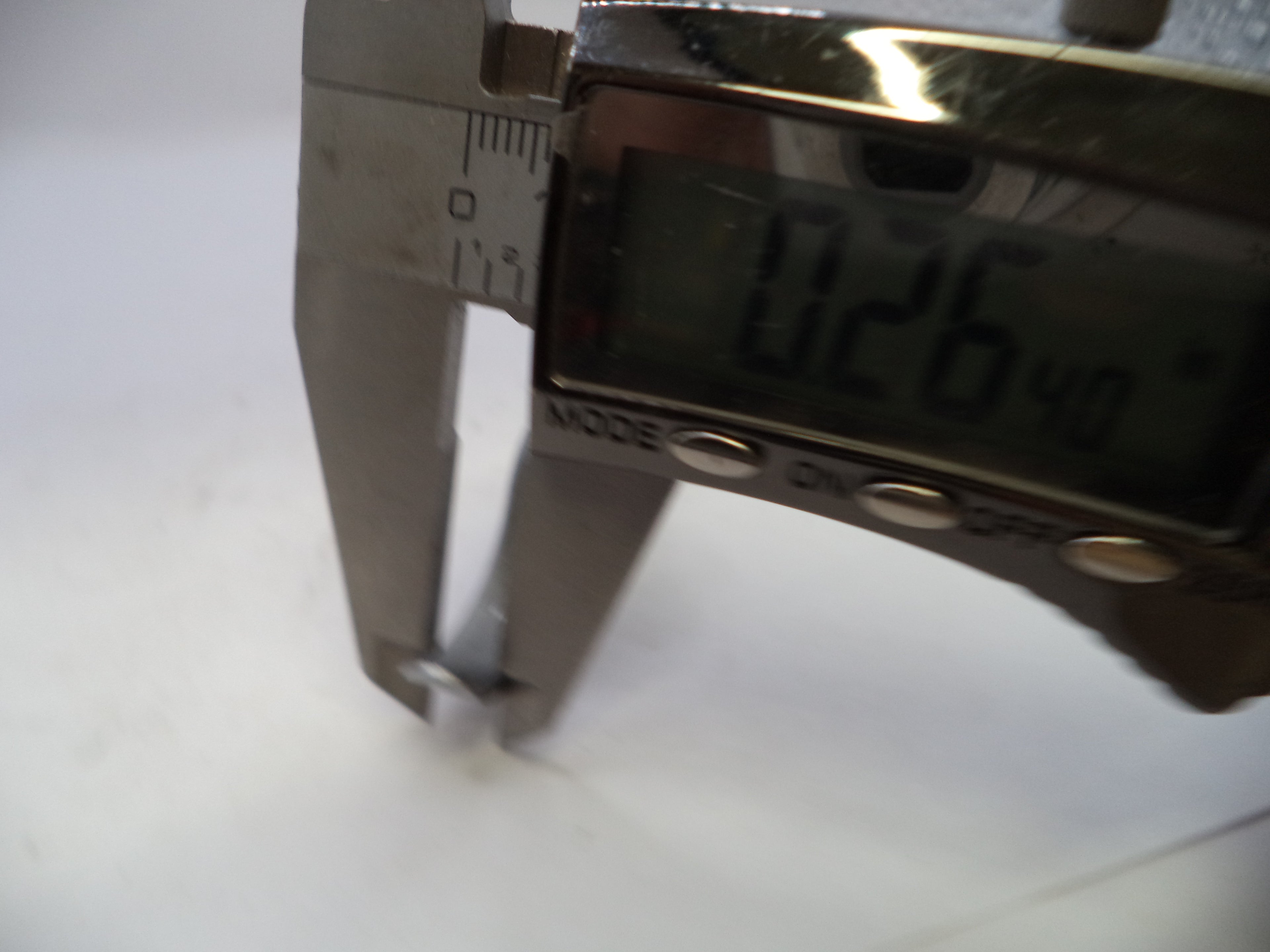 Digital caliper showing a measurement on a white background