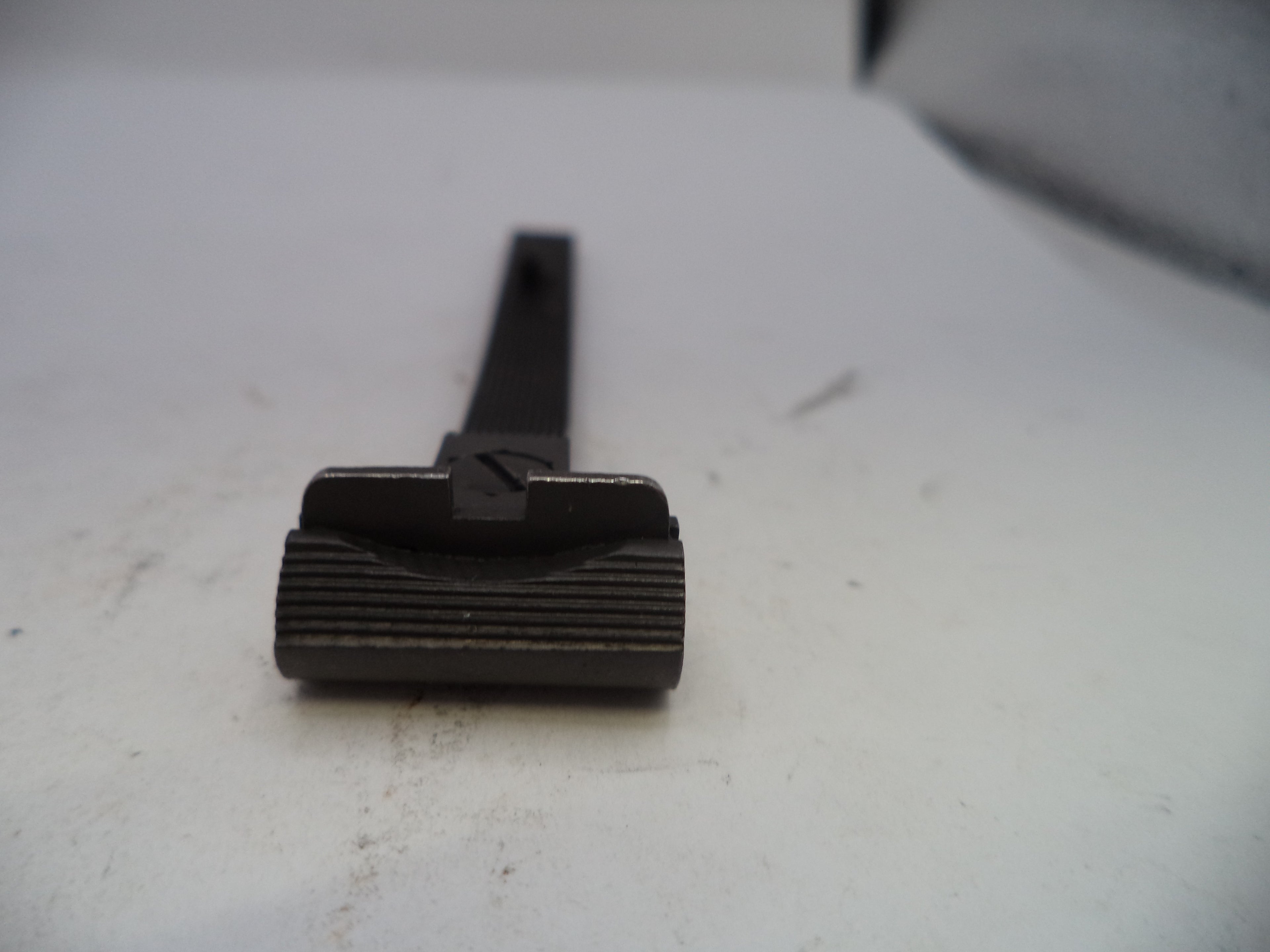 Black metal tool on a white surface