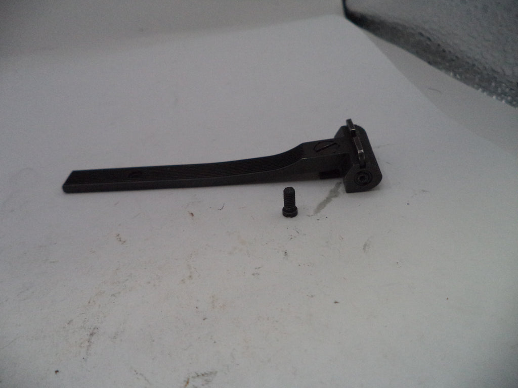 Black metal lever and cylindrical component on a white surface