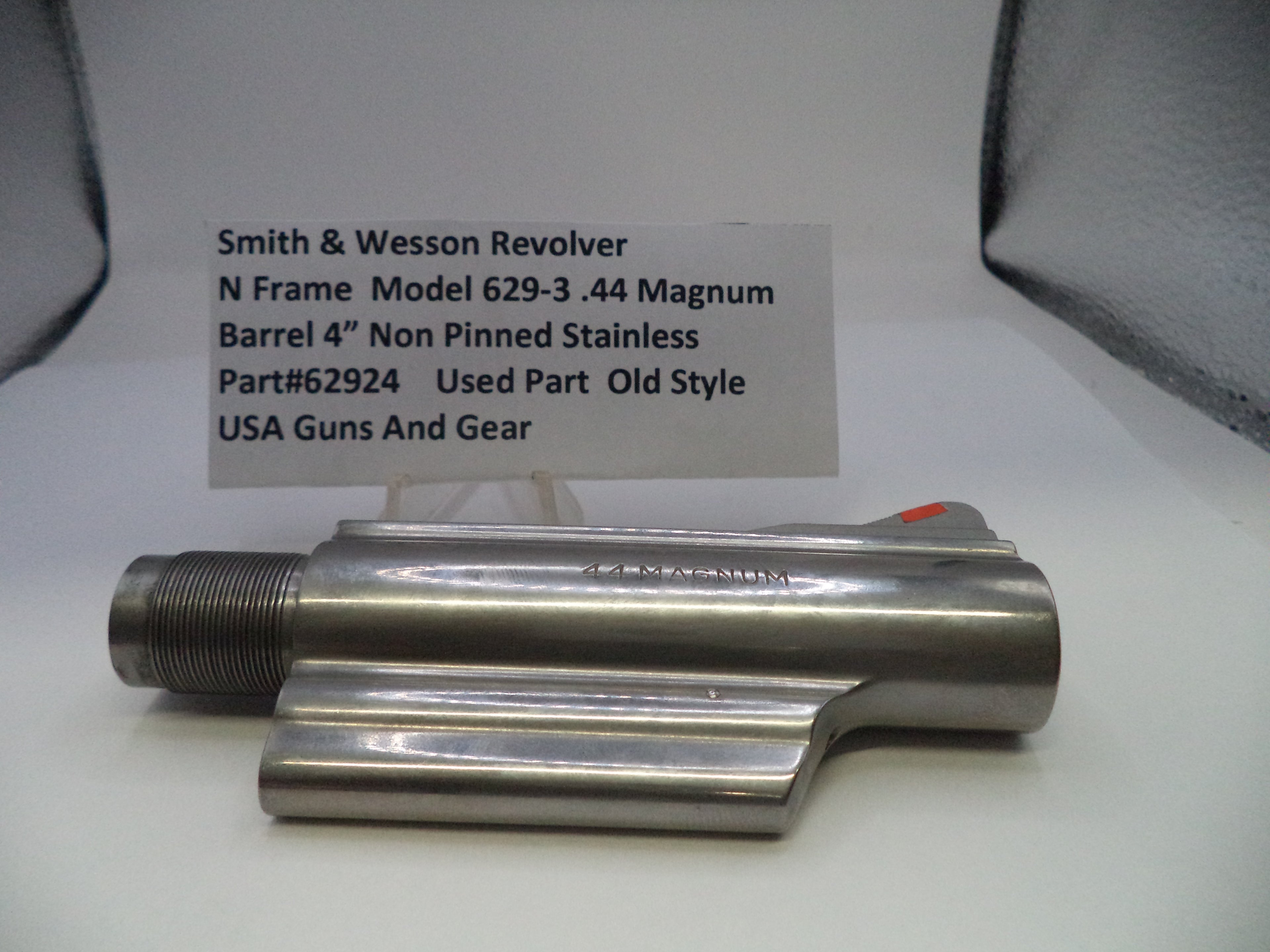 Smith & Wesson revolver barrel on a white surface with a label