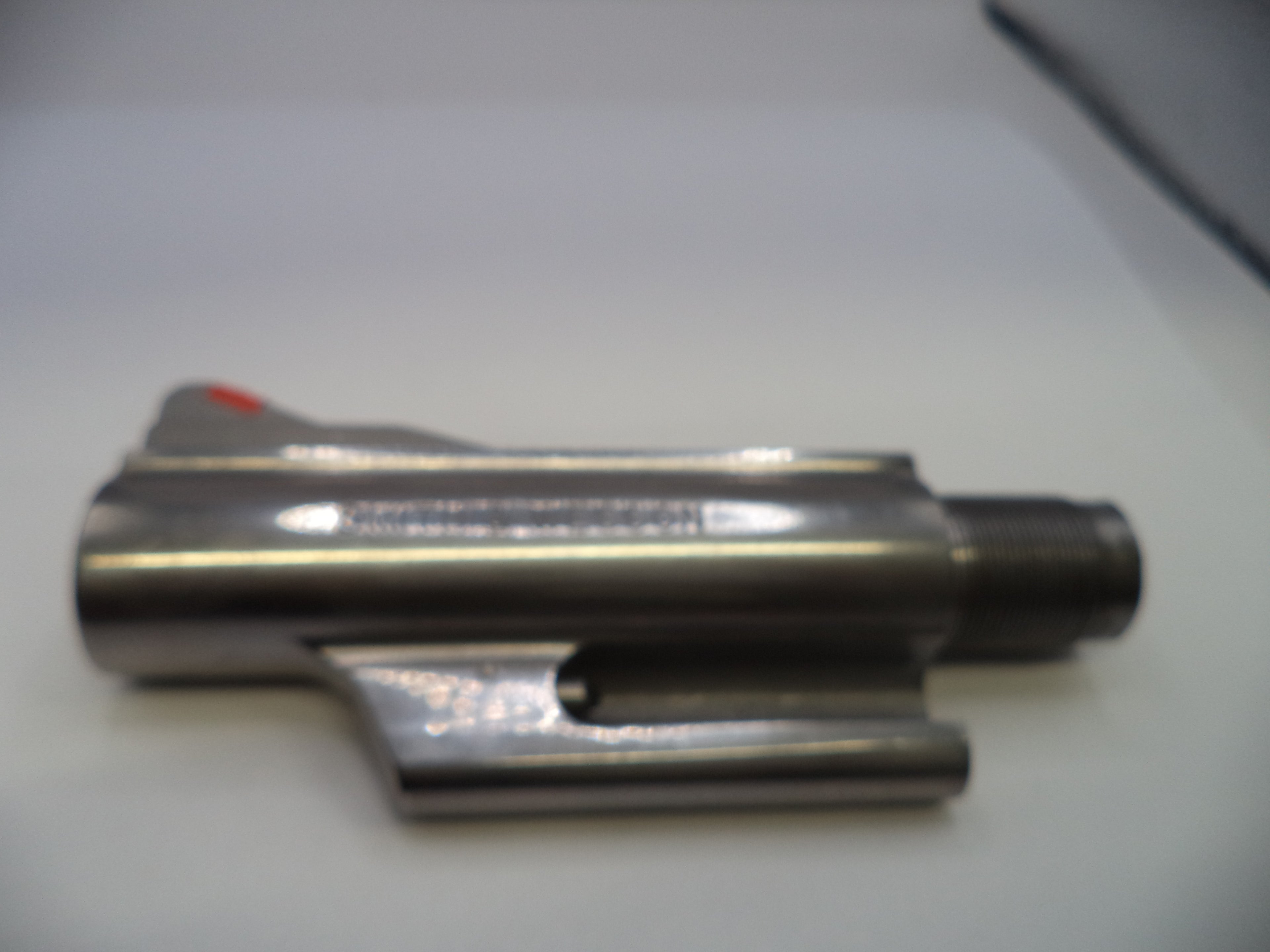 Metallic object on a white surface