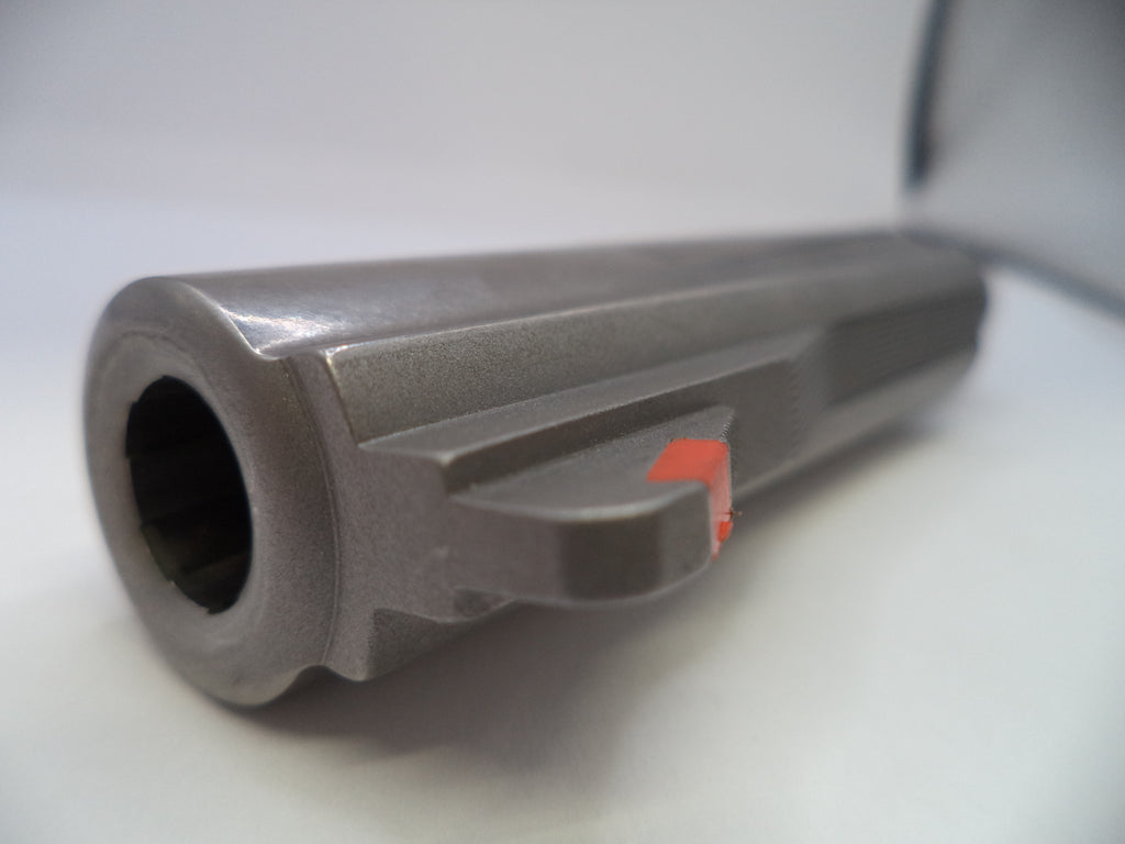 Close-up of a metallic cylindrical object with a red label on a white background