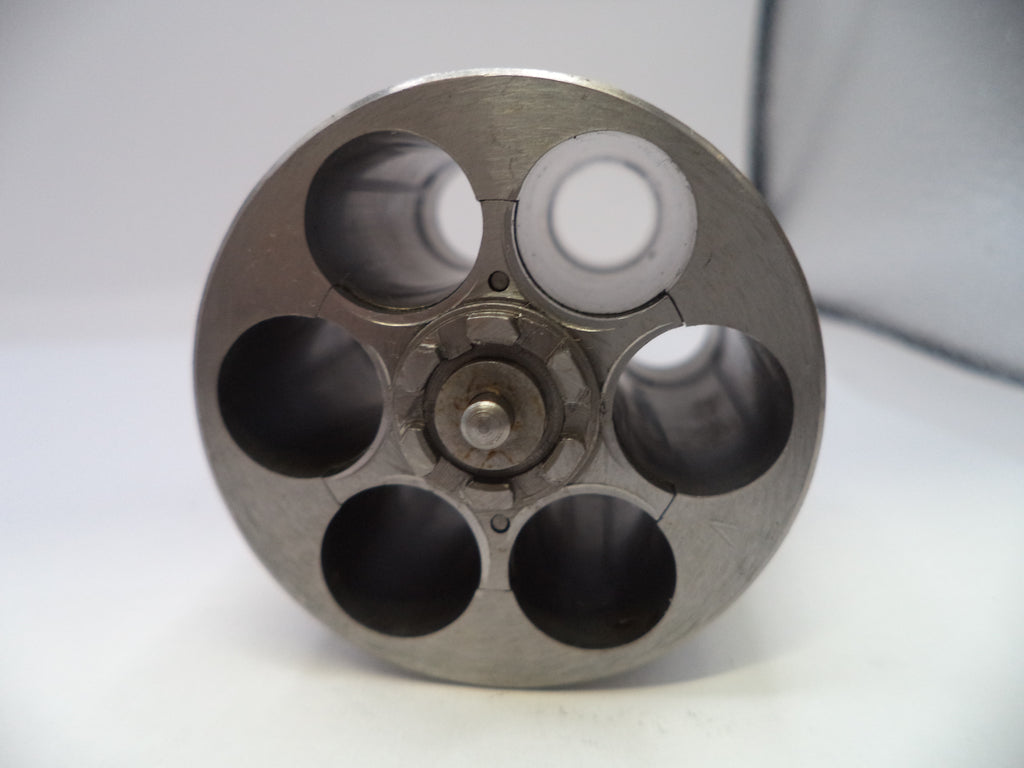 Metallic cylindrical object with multiple chambers on a white background