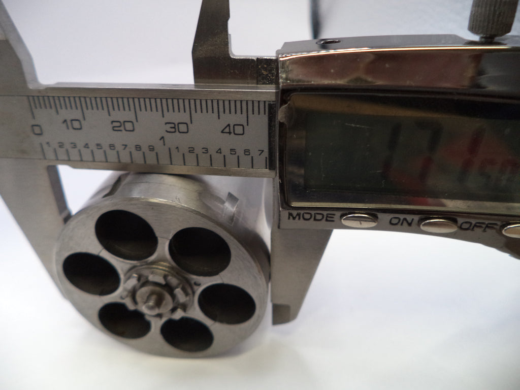 Caliper measuring a cylindrical metal object with a digital display on a white background