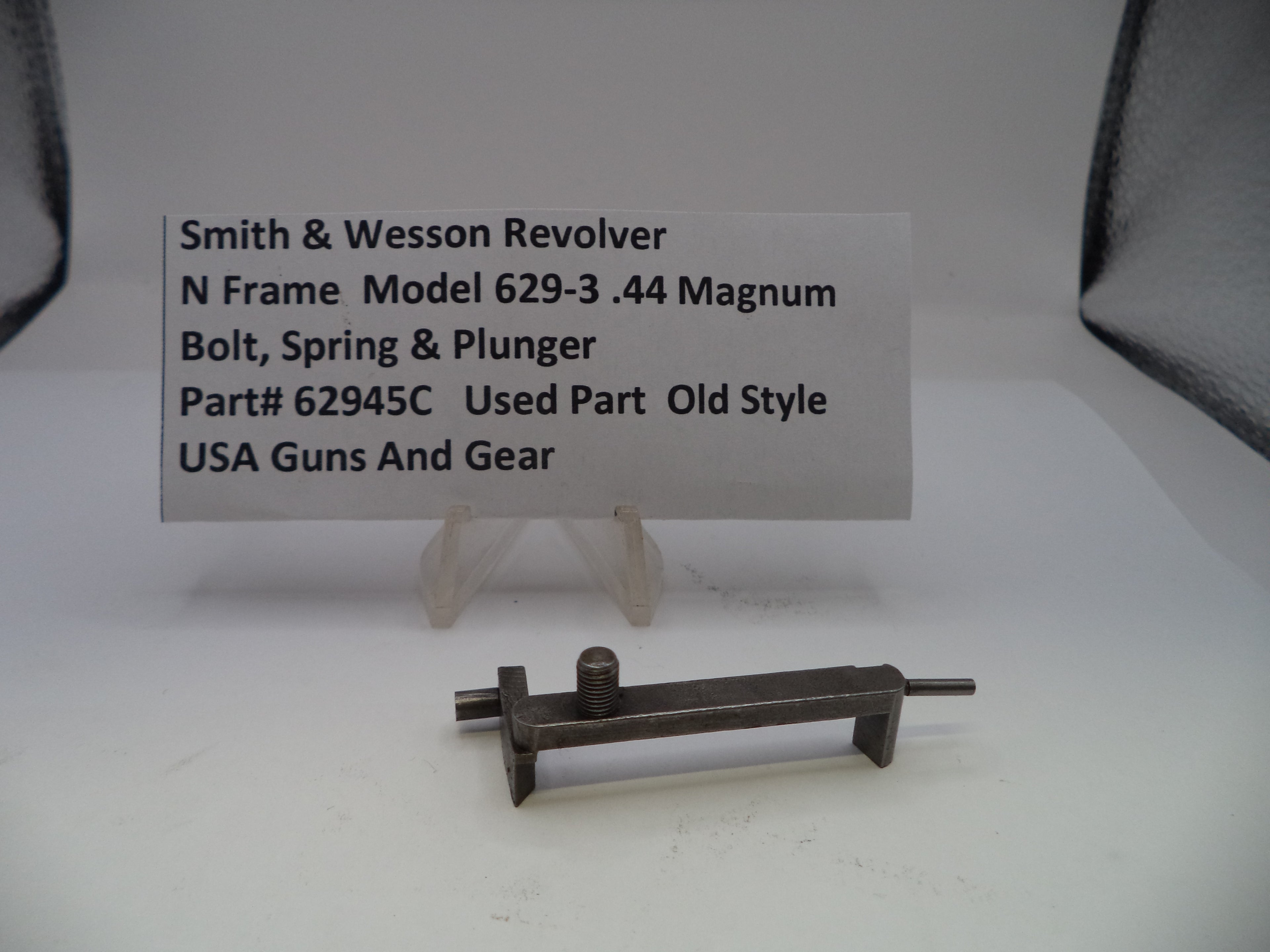 Gun part with a label on a white background