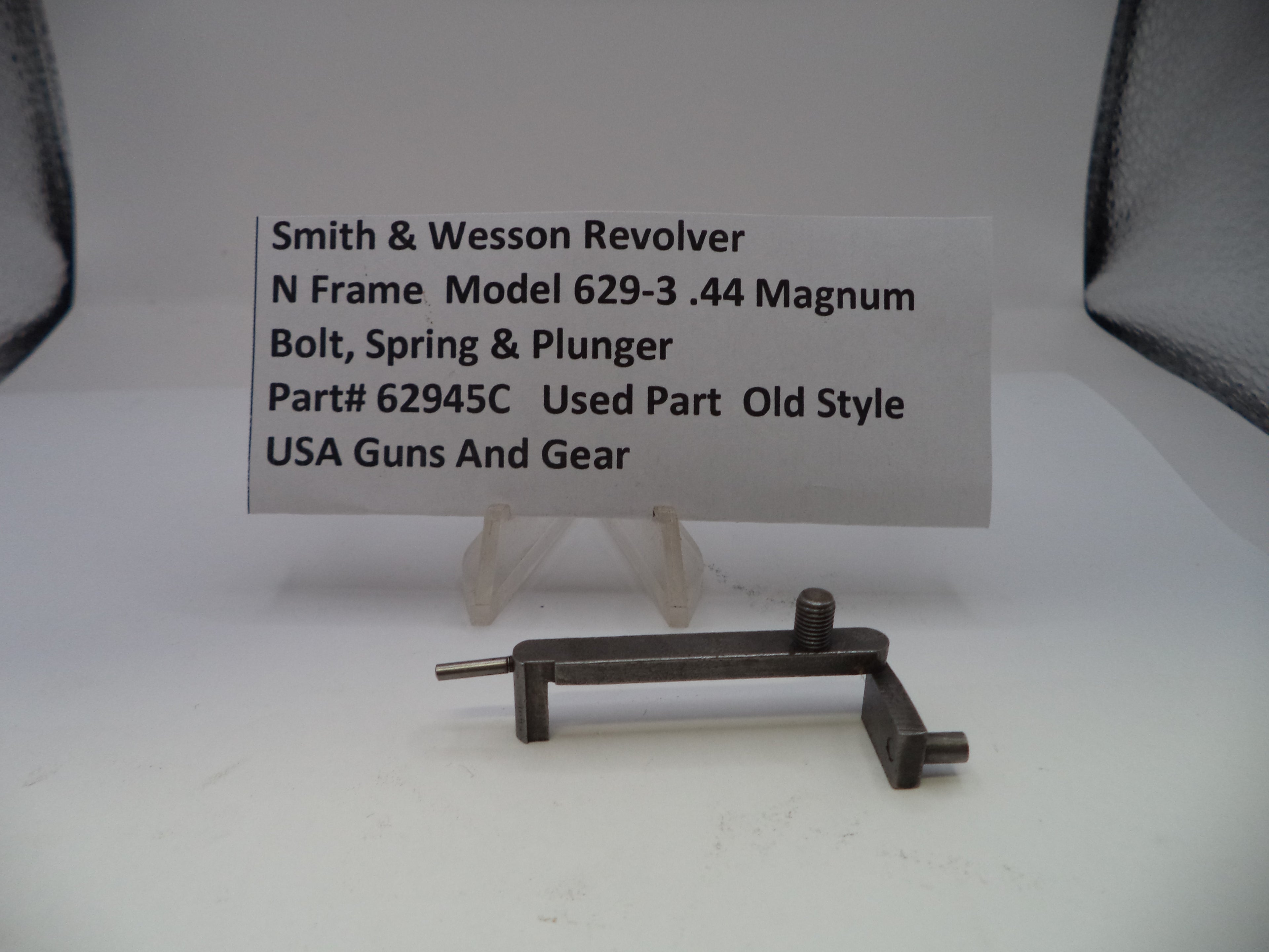 Smith & Wesson revolver part on a white background with a label