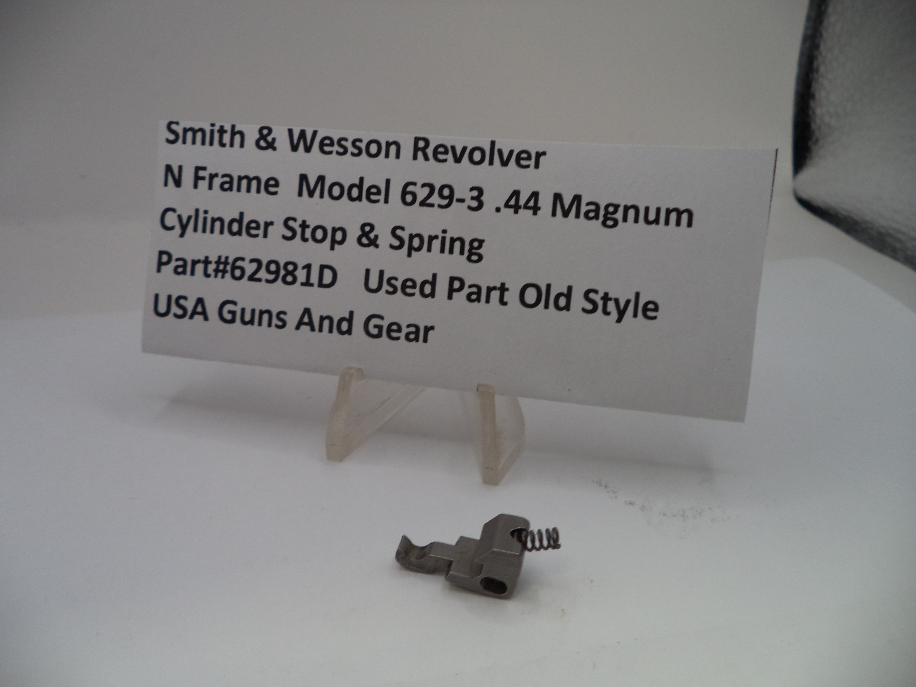 Smith & Wesson revolver part with a label on a white background