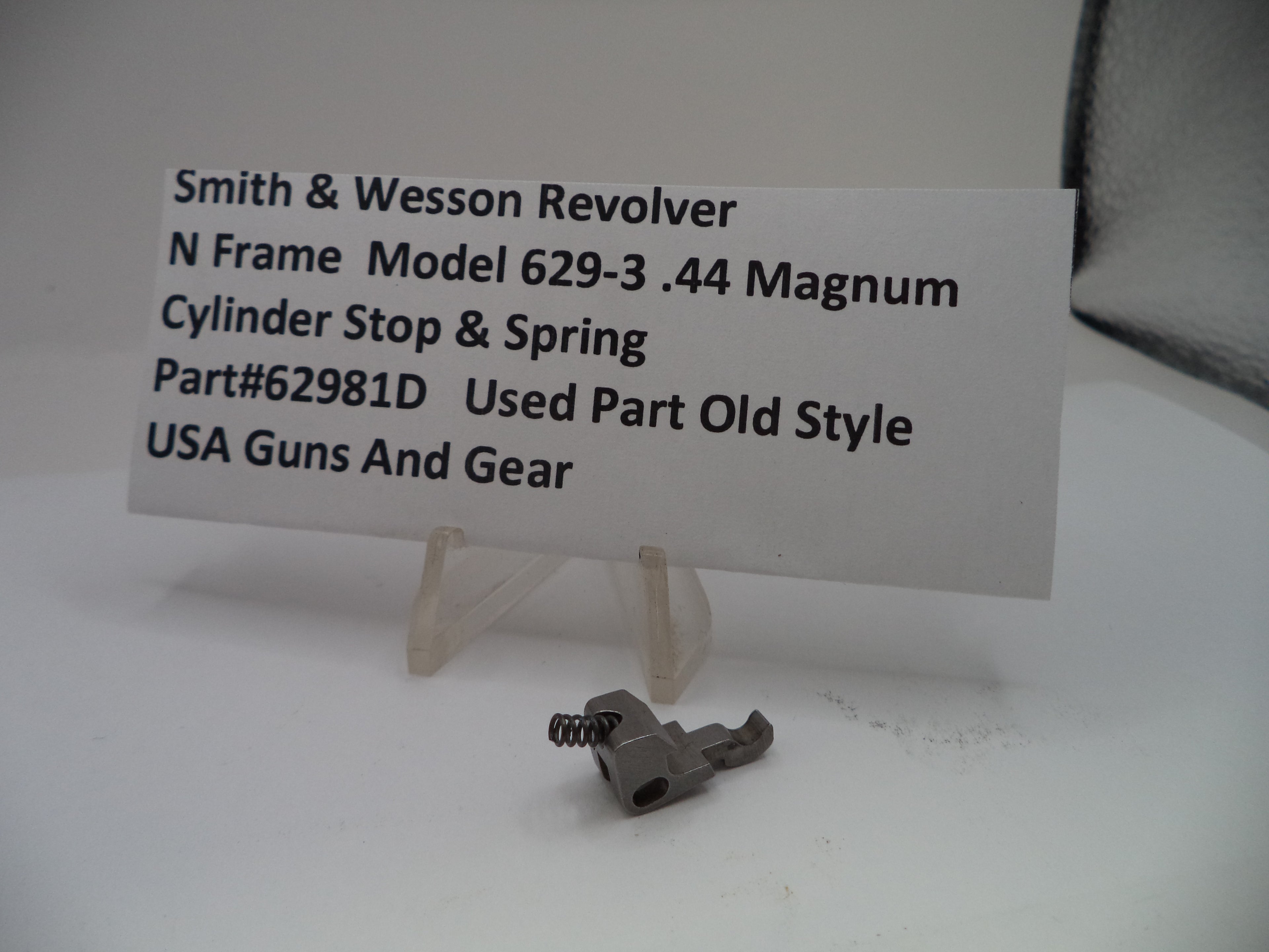 Smith & Wesson revolver part with a label on a white background