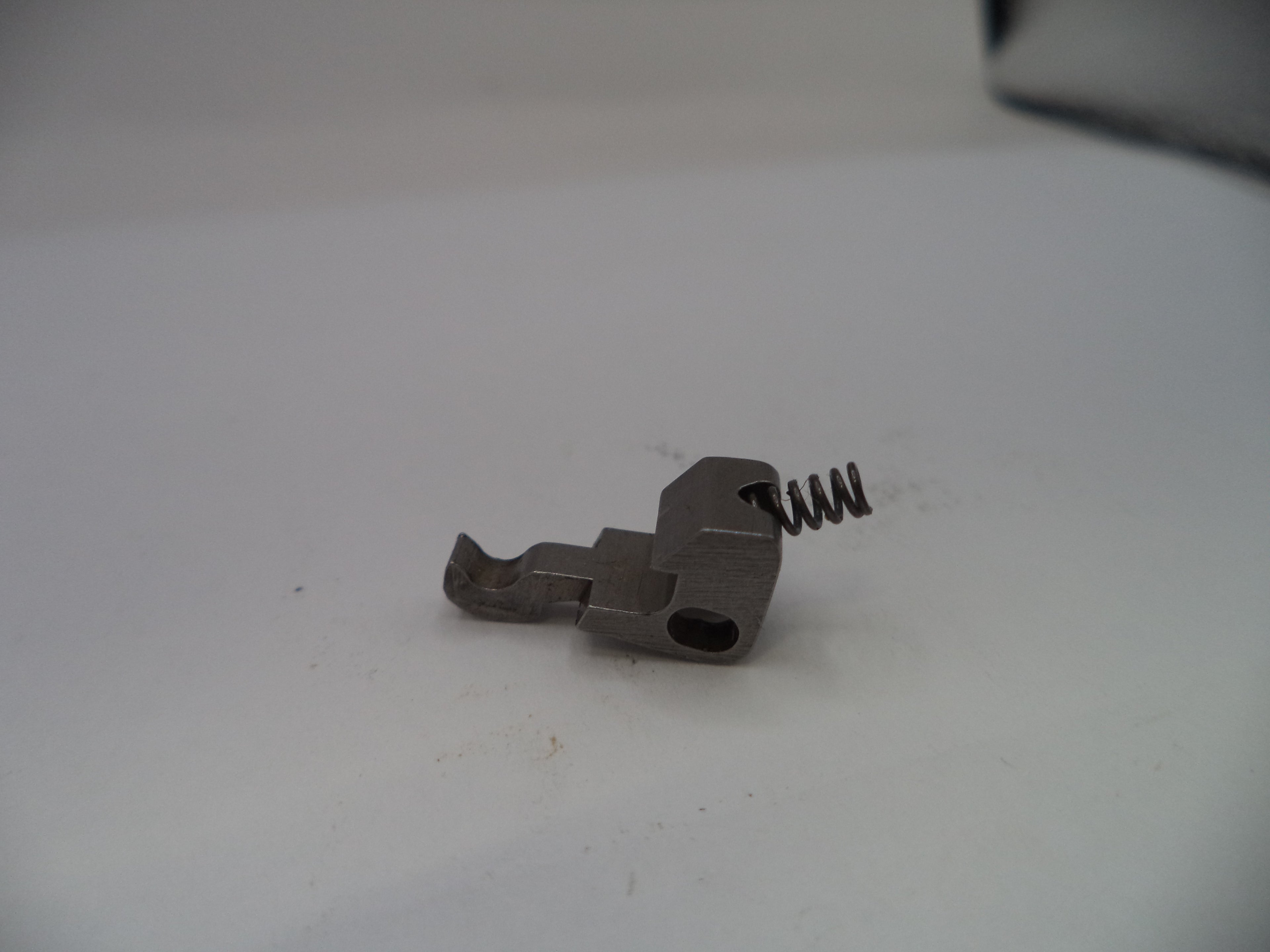 Metal component with a spring on a white background