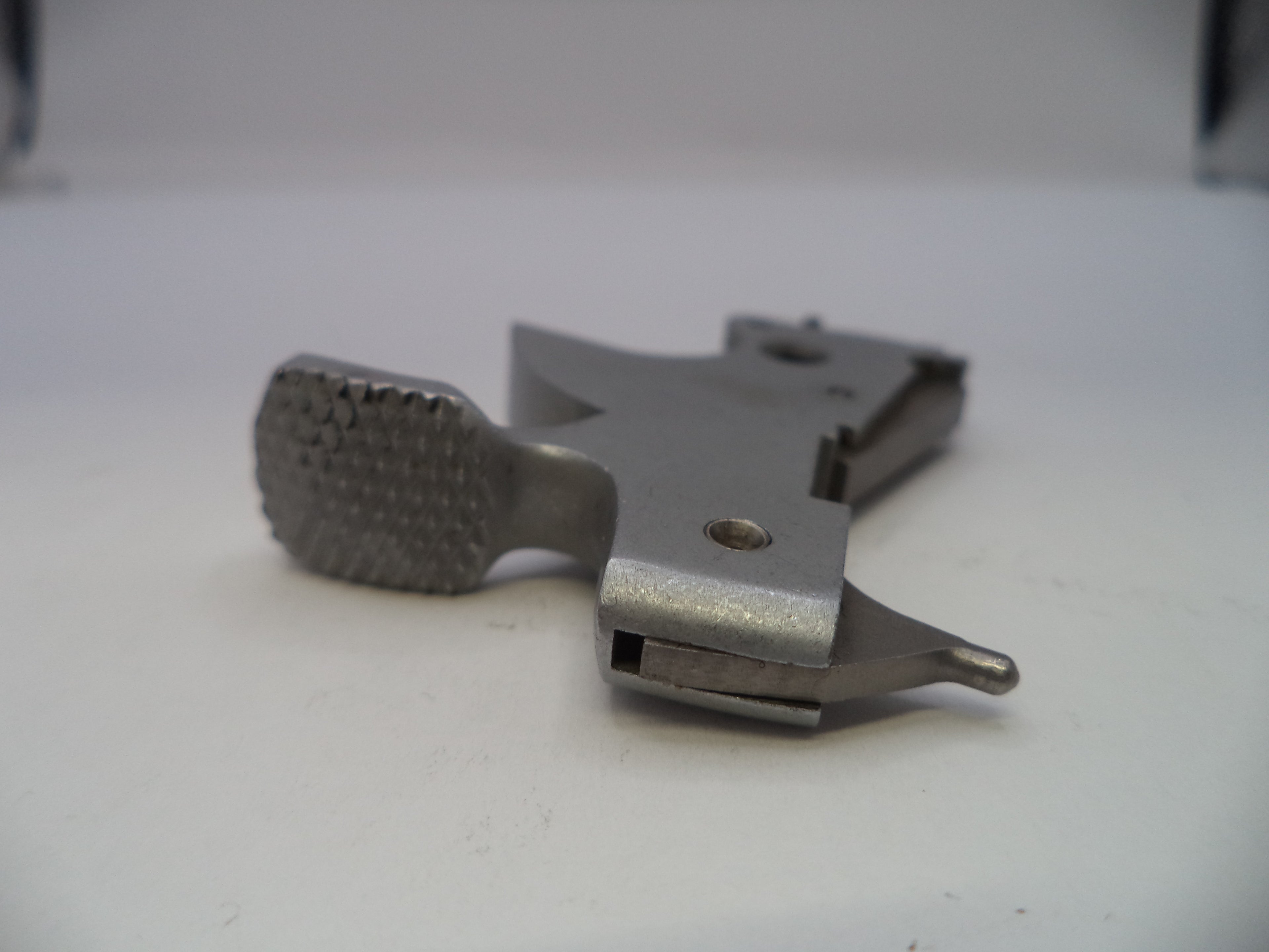 Metal tool with textured end on a white background