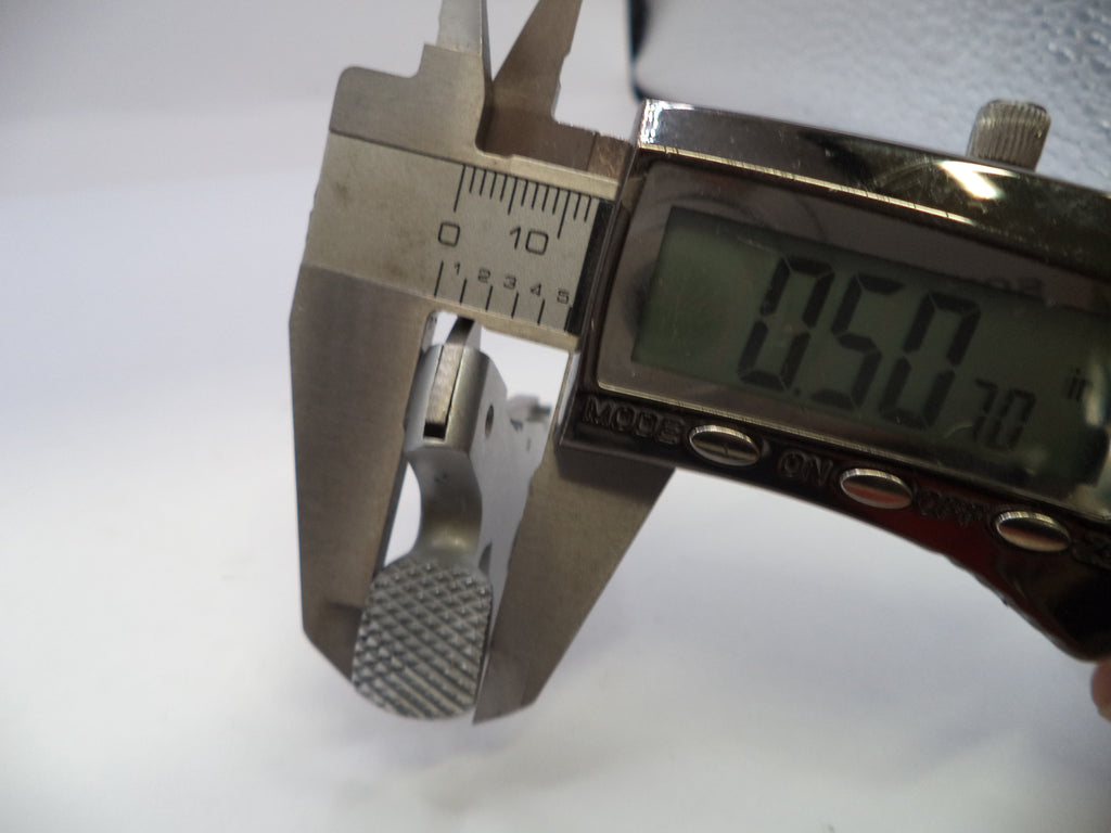Digital caliper measuring a small object with a white background