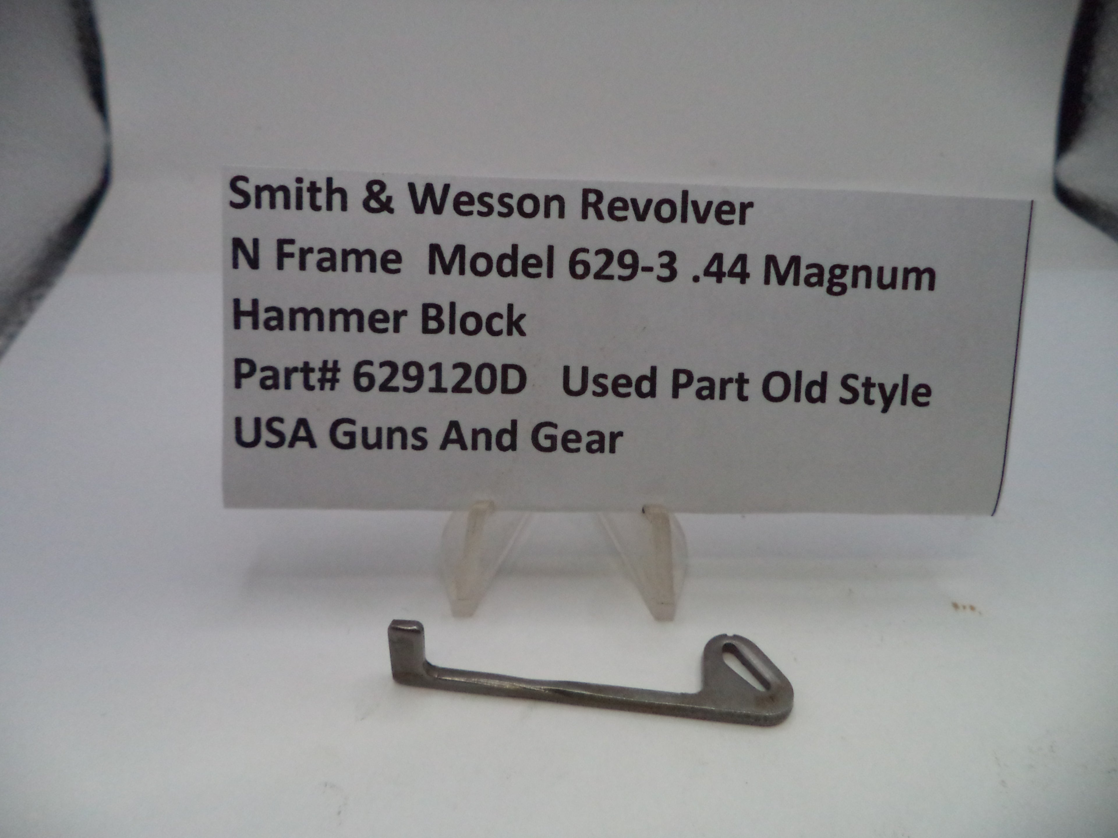Smith & Wesson revolver hammer block on a white background with a label.