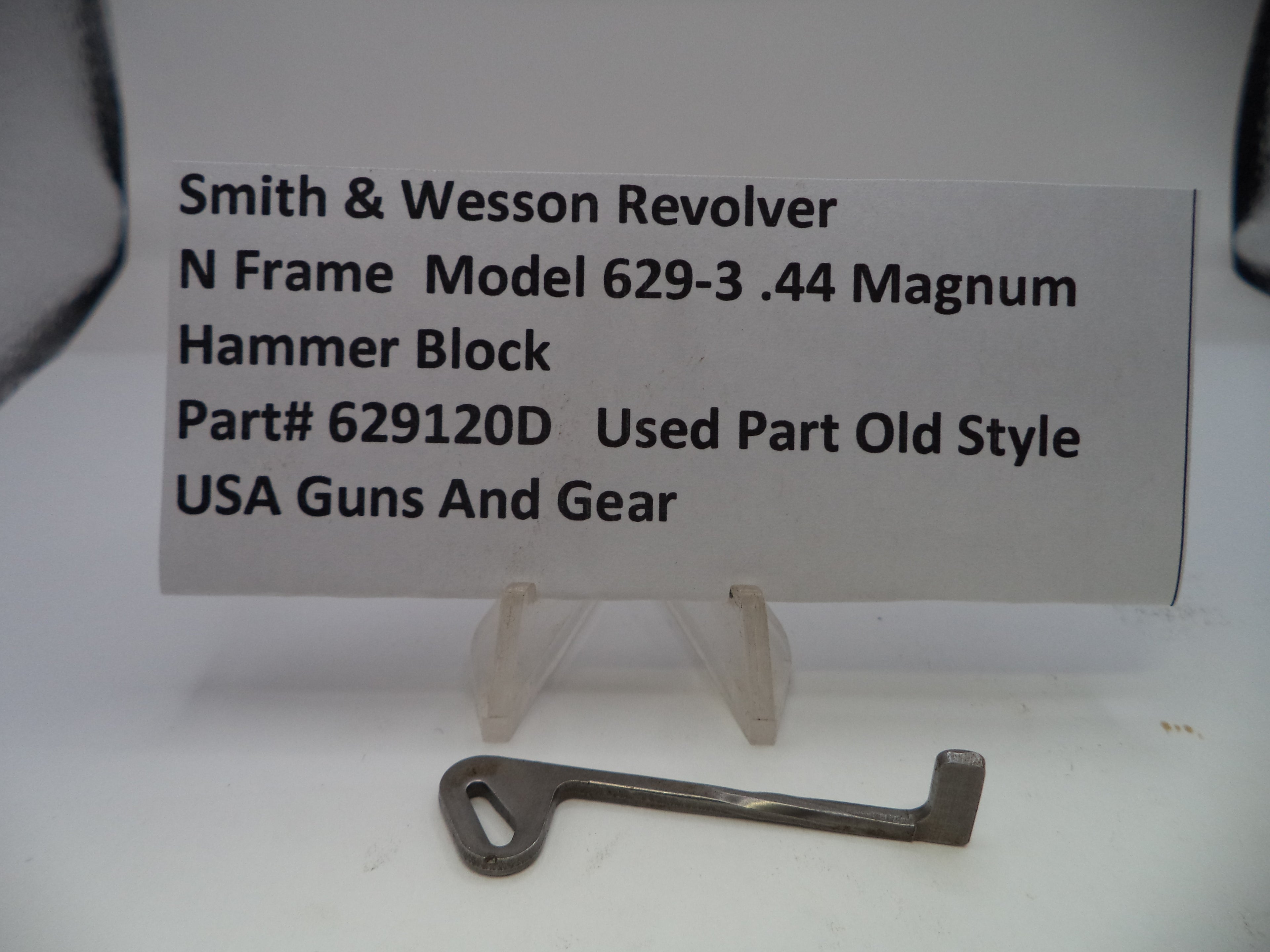 Smith & Wesson revolver hammer block part with descriptive label on a white background