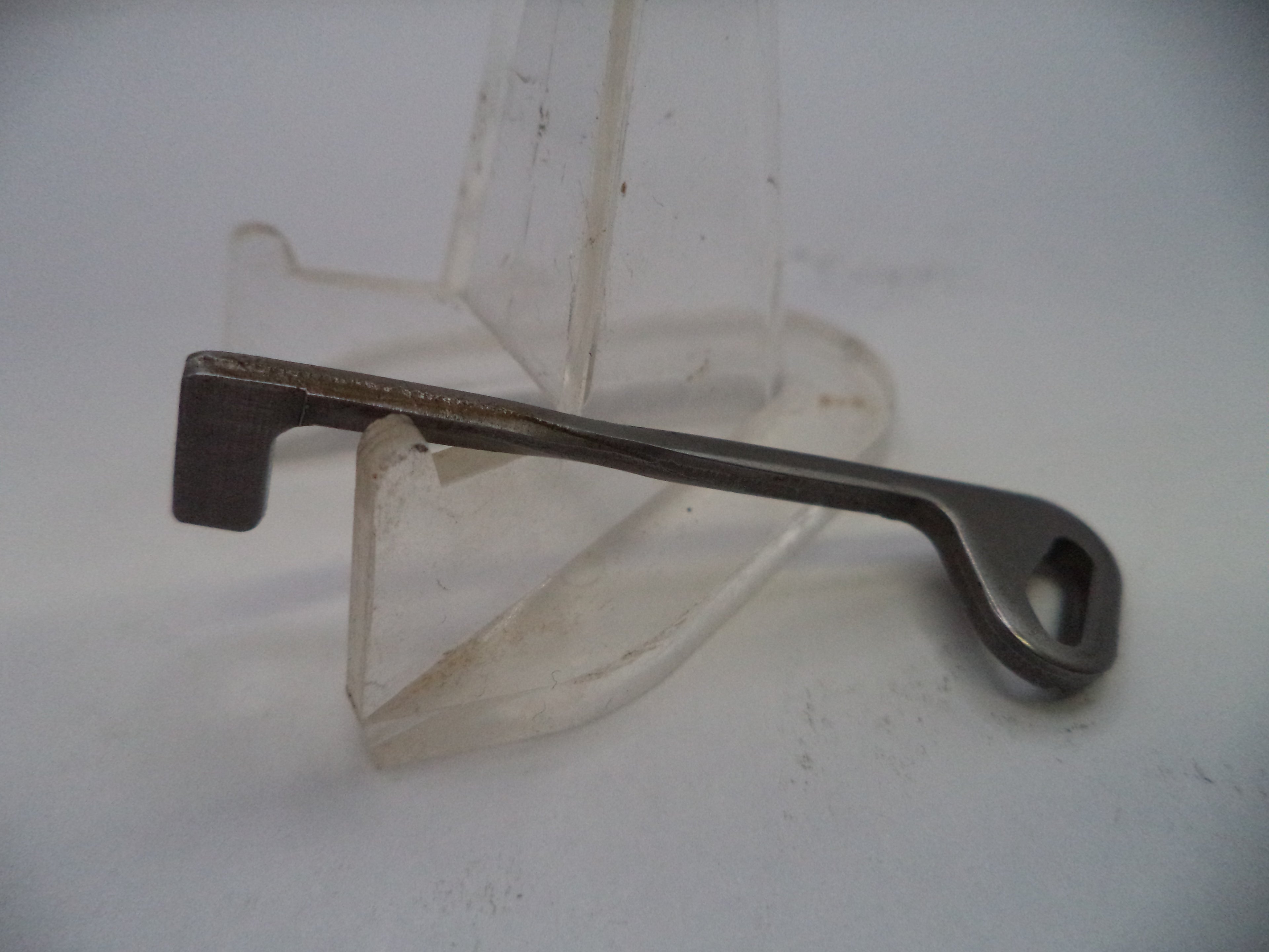 Metal tool on a stand against a white background
