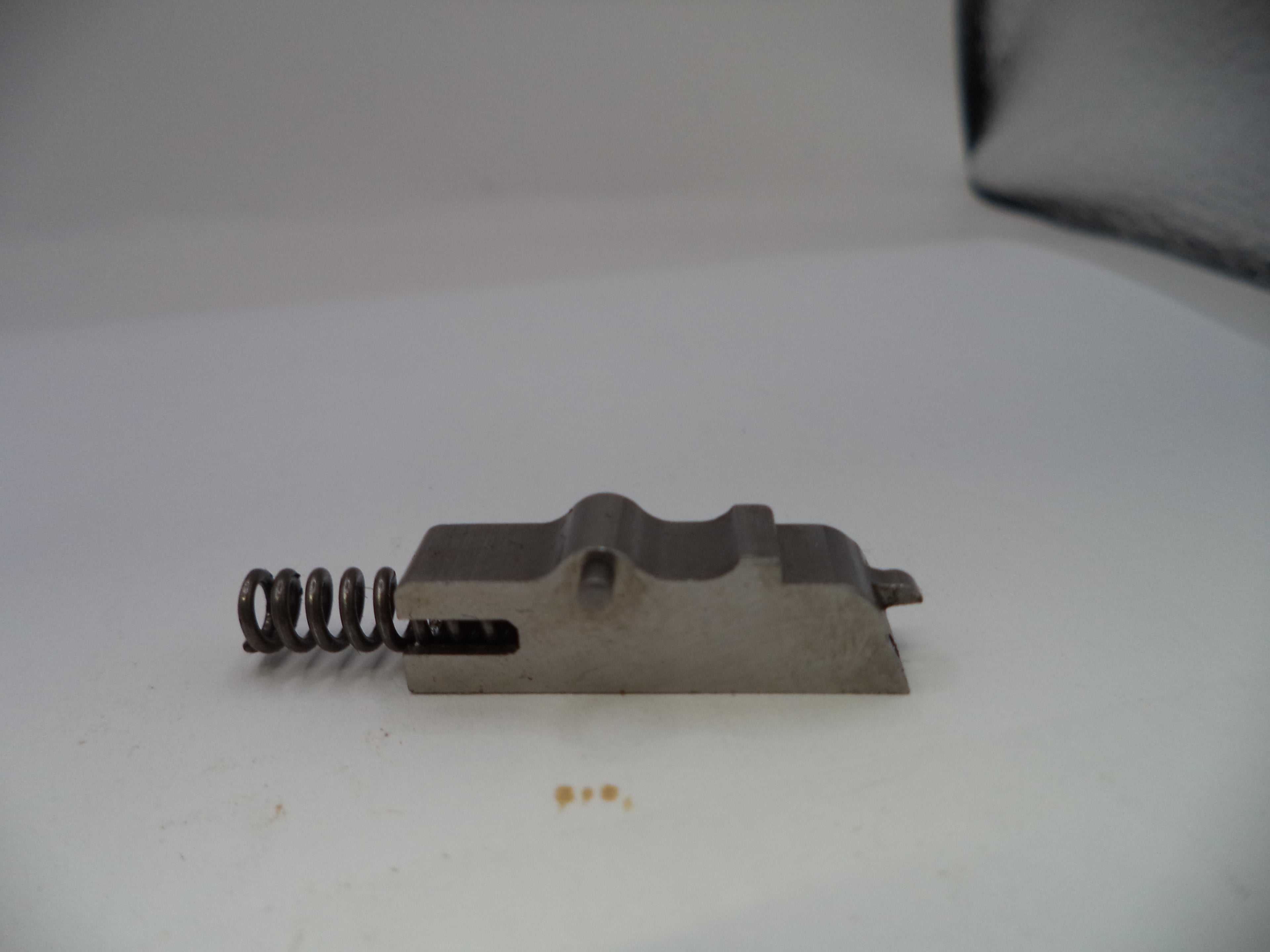 Metal component with a spring on a white background