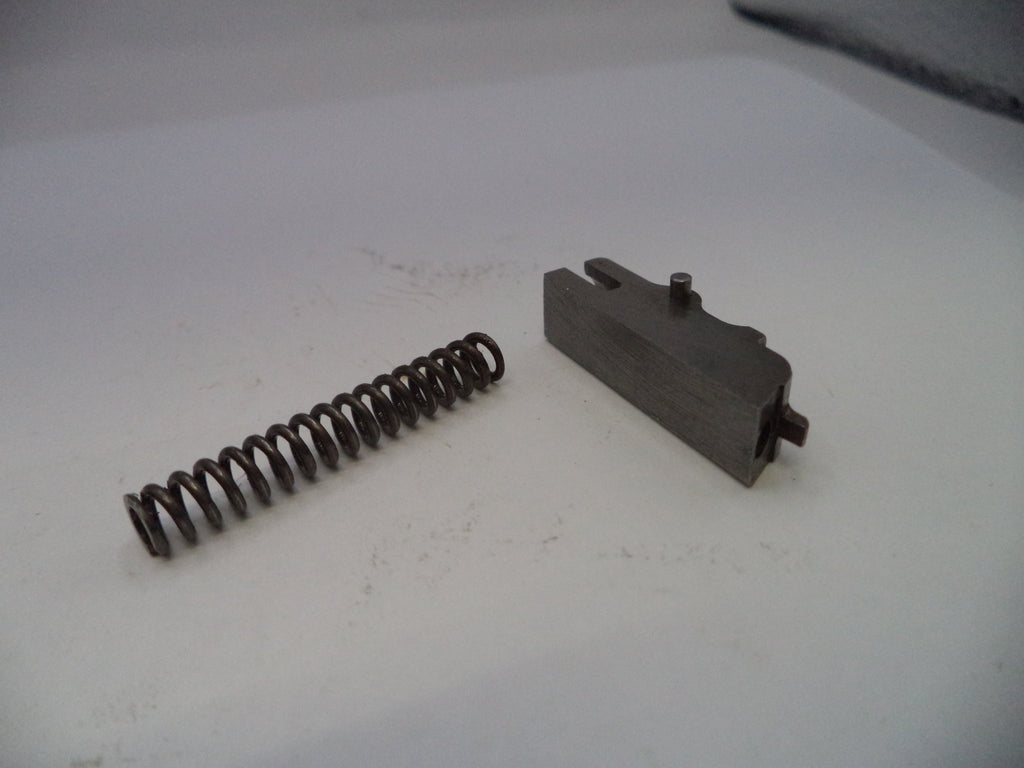 Metal spring and mechanical component on a white surface