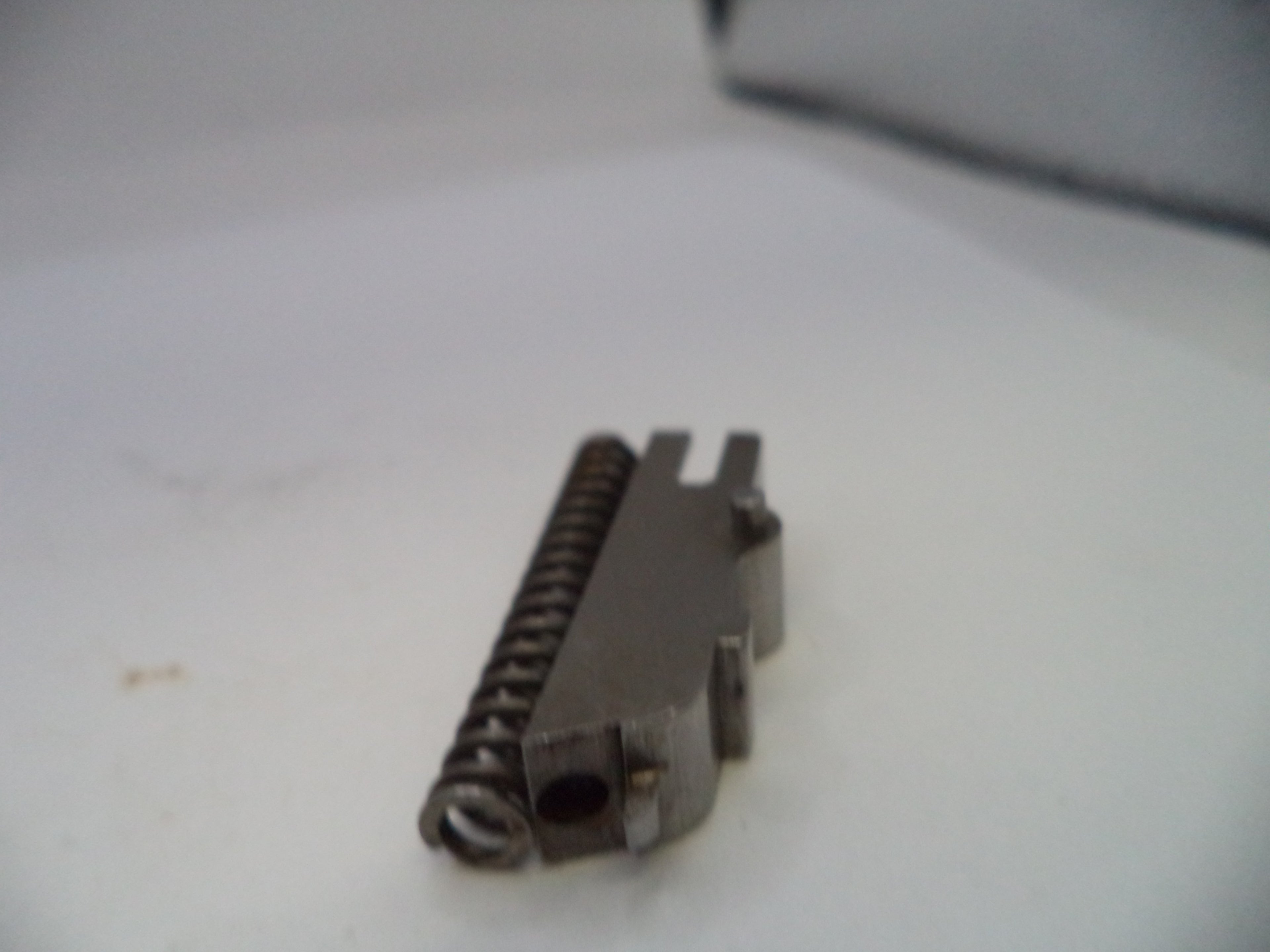 Metal component on a white surface