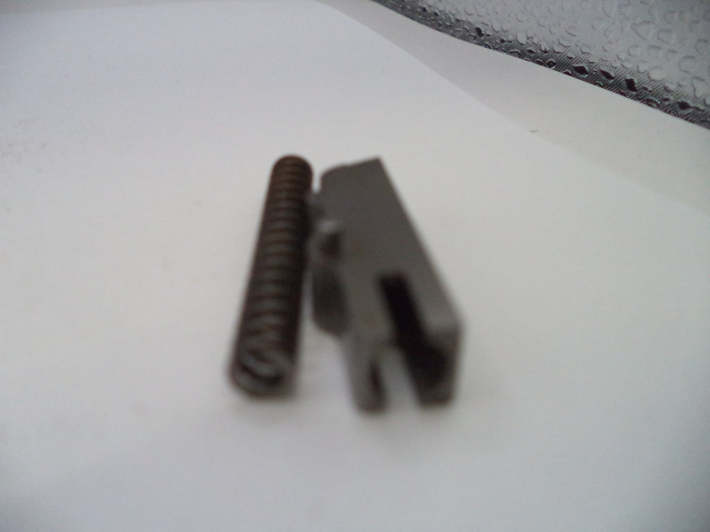 Metal spring and clip on a white surface