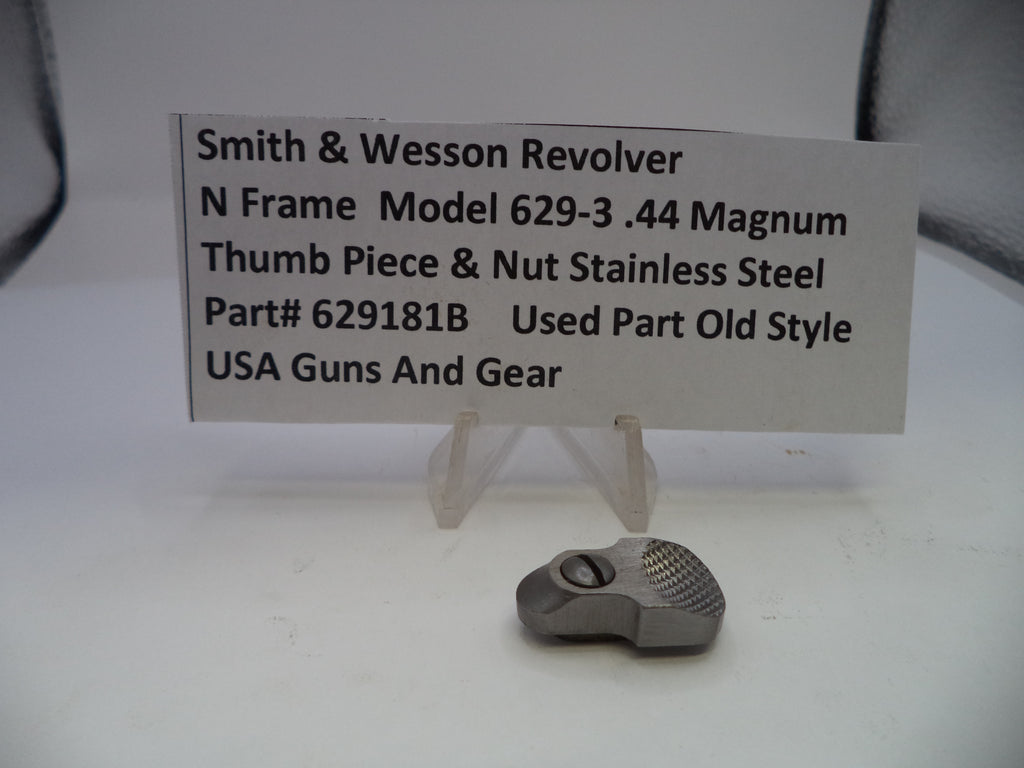 Smith & Wesson revolver thumb piece and nut on a white background with a label.