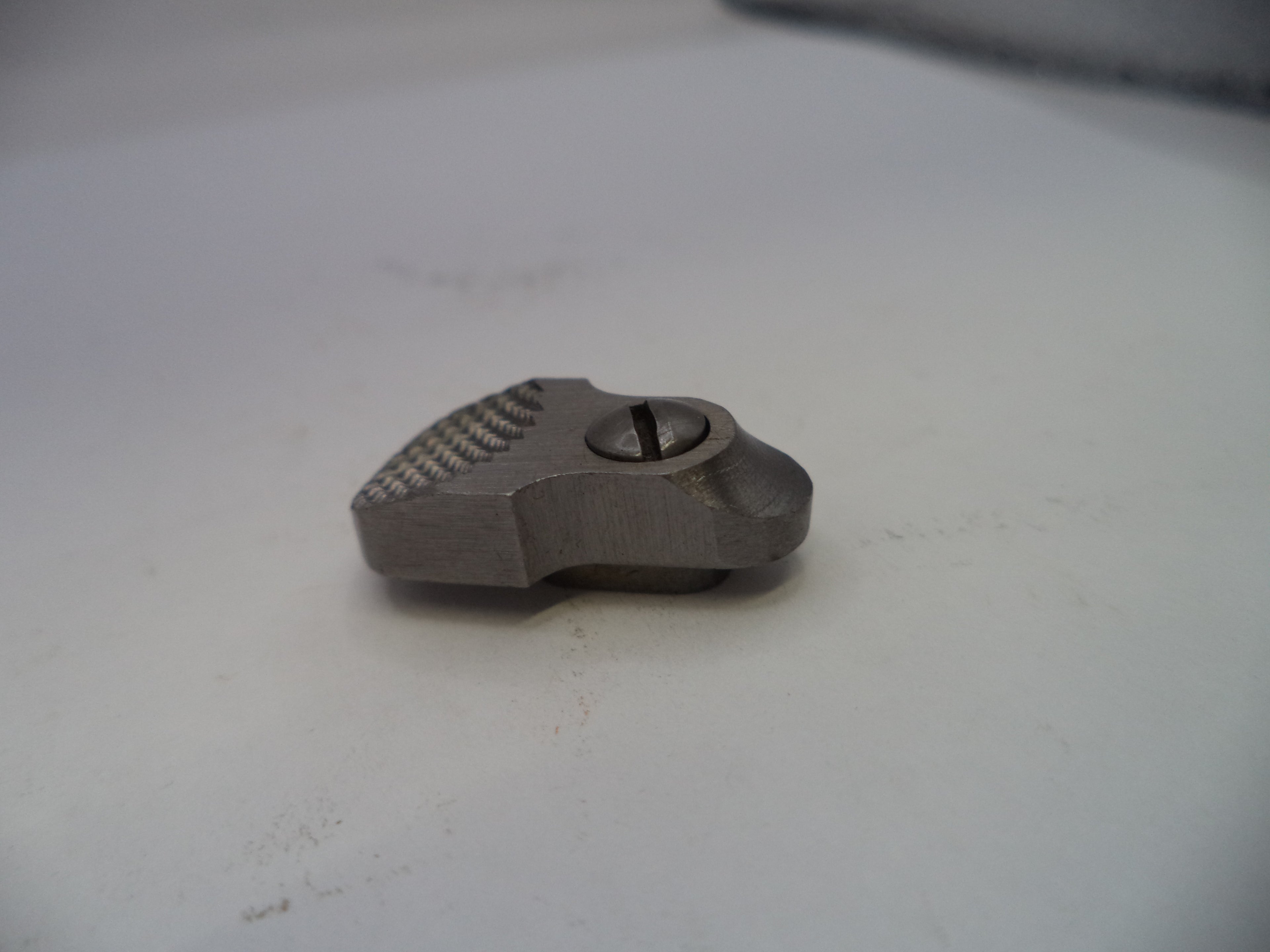 Metallic object on a white surface