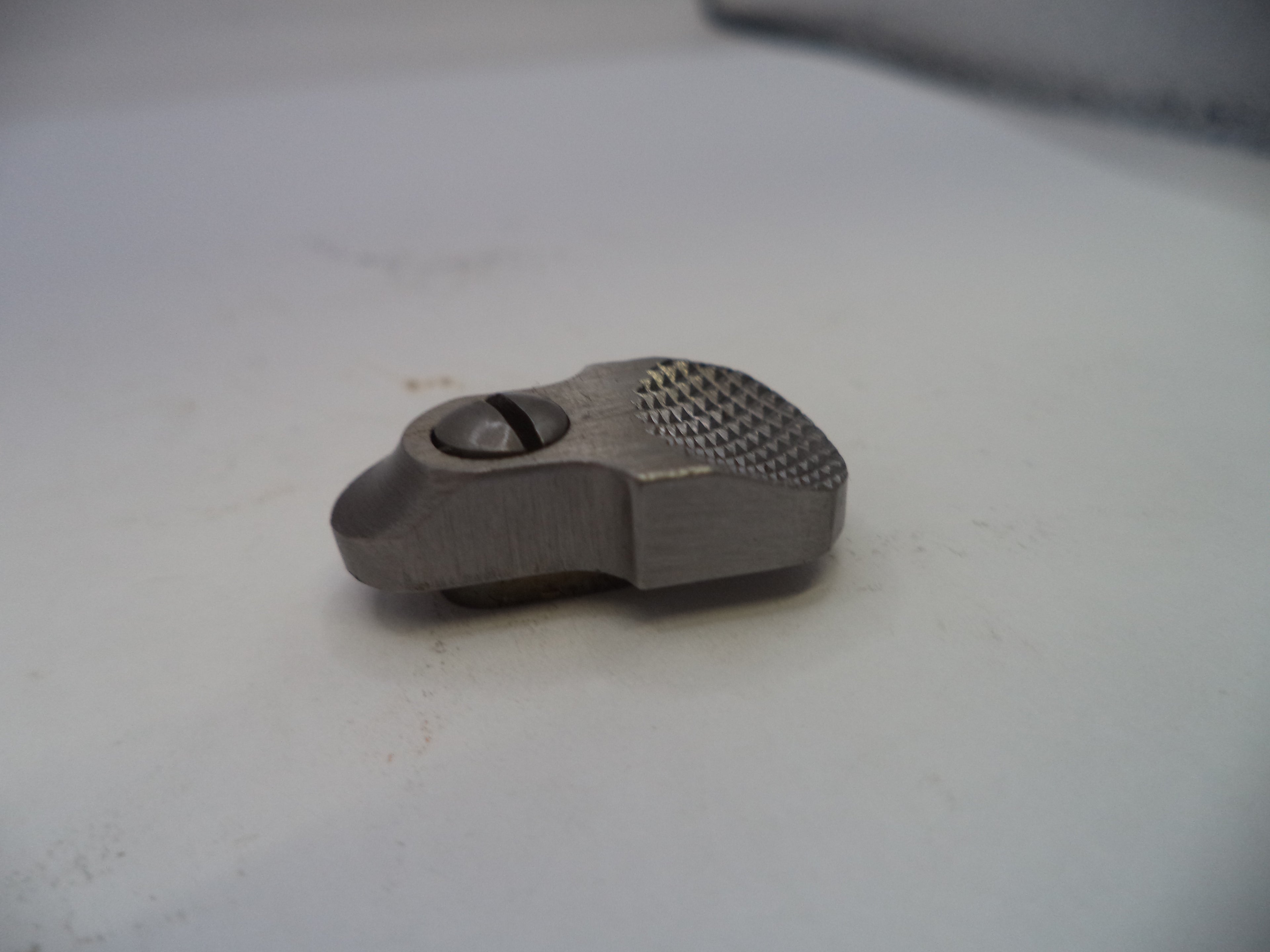 Metal component on a white surface