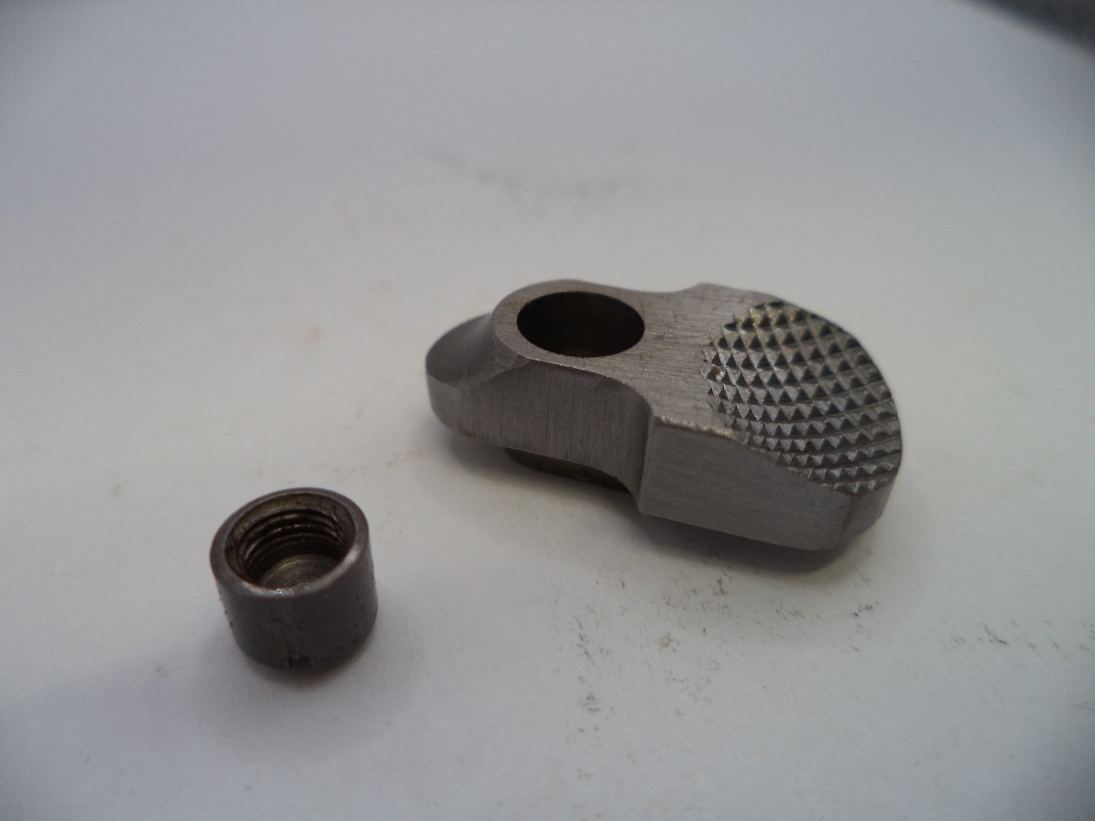 Two metal components on a white surface