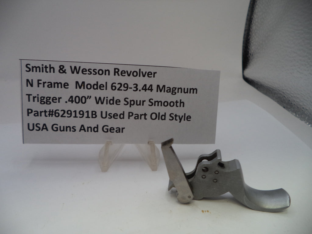 Smith & Wesson revolver trigger part with descriptive card on a white background