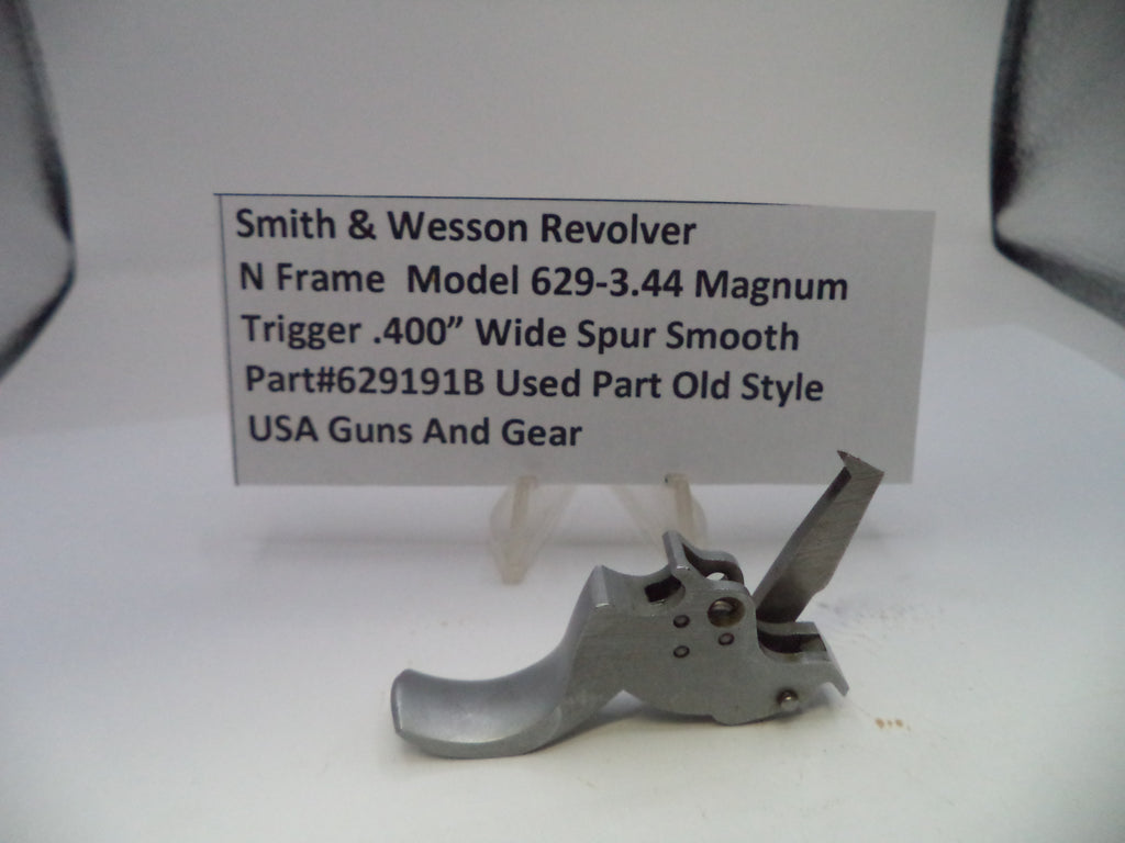 Smith & Wesson revolver trigger part with descriptive card on a white background