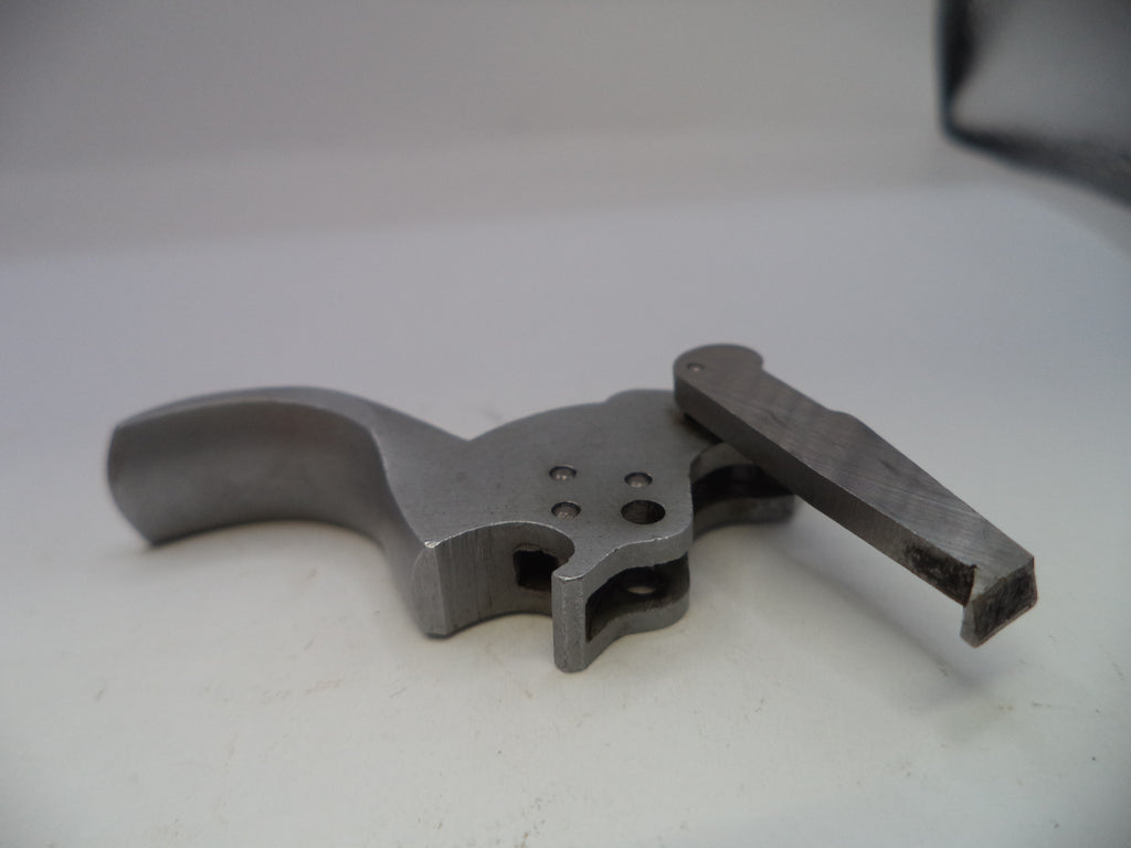 Metal gun trigger on a white background