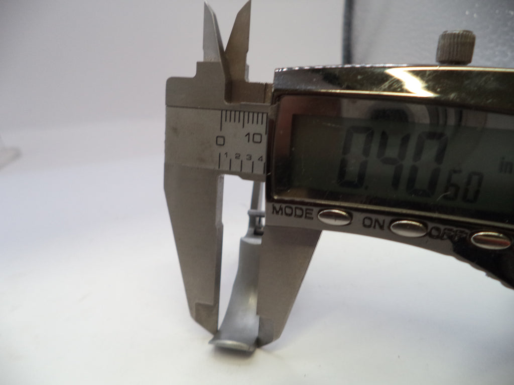 Digital caliper measuring a small object with a white background