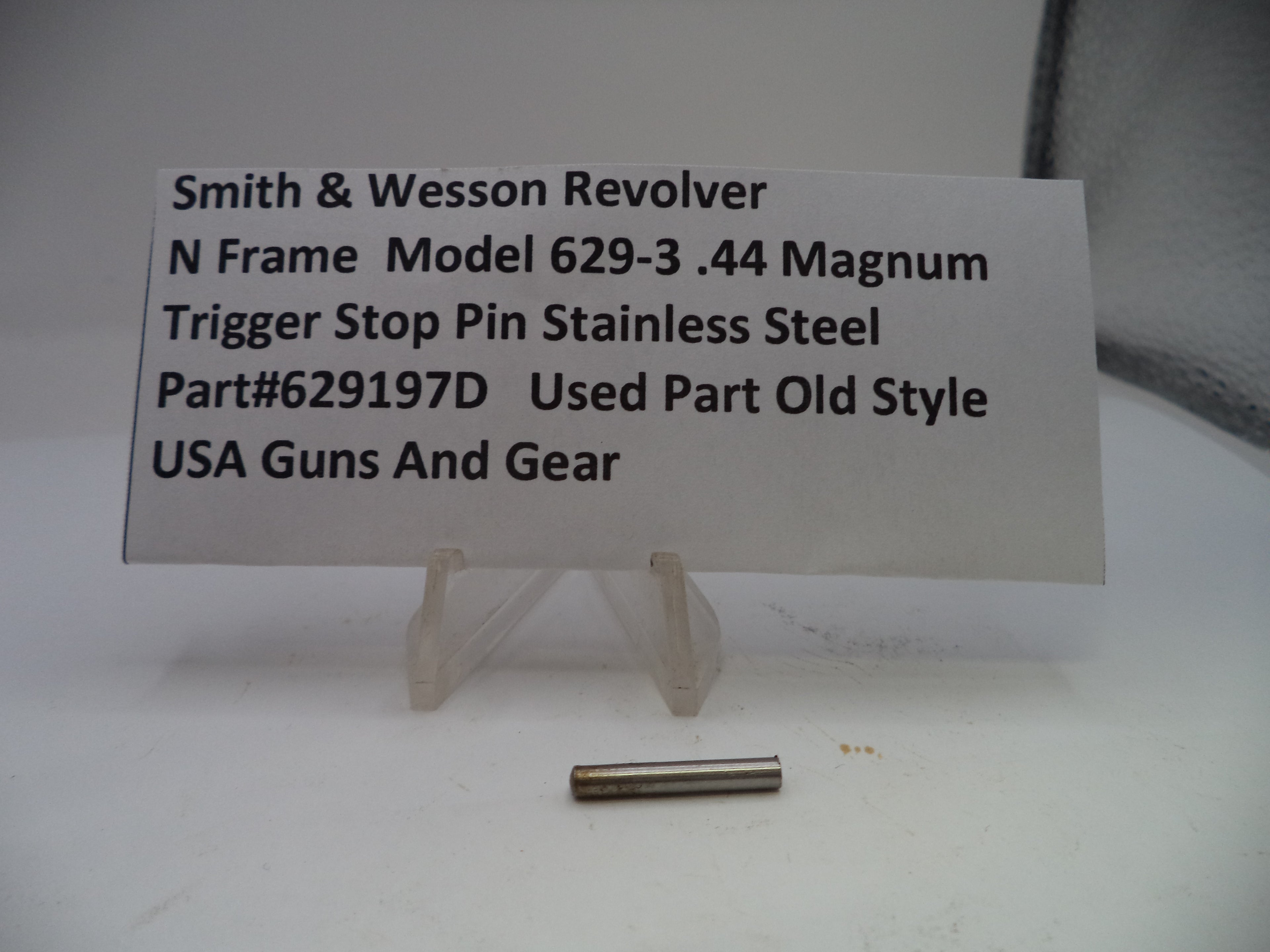 Smith & Wesson revolver part with descriptive card on a white background