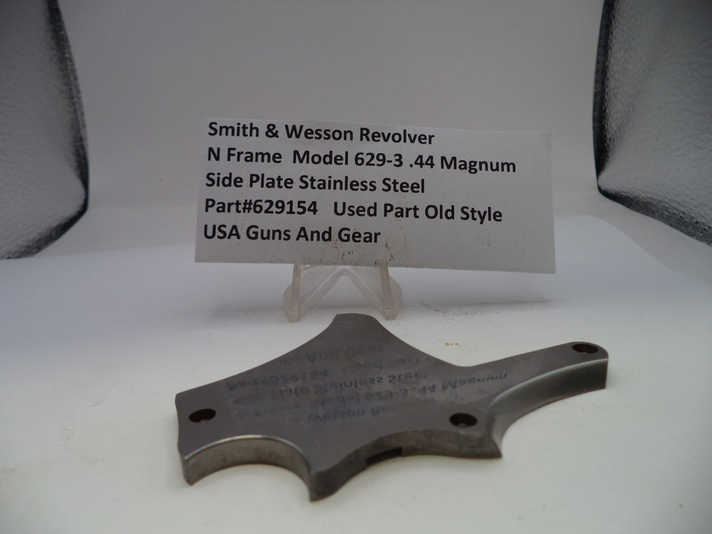 Smith & Wesson revolver side plate on a white background with a label.