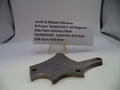 Smith & Wesson revolver side plate on a white background with a label.
