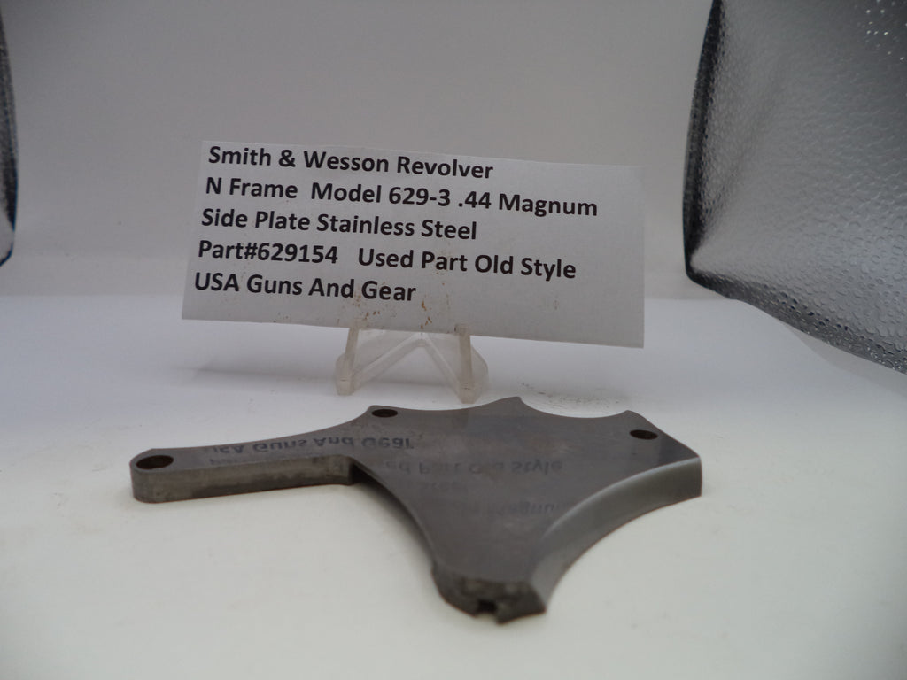 Smith & Wesson revolver side plate on a white background with a label.