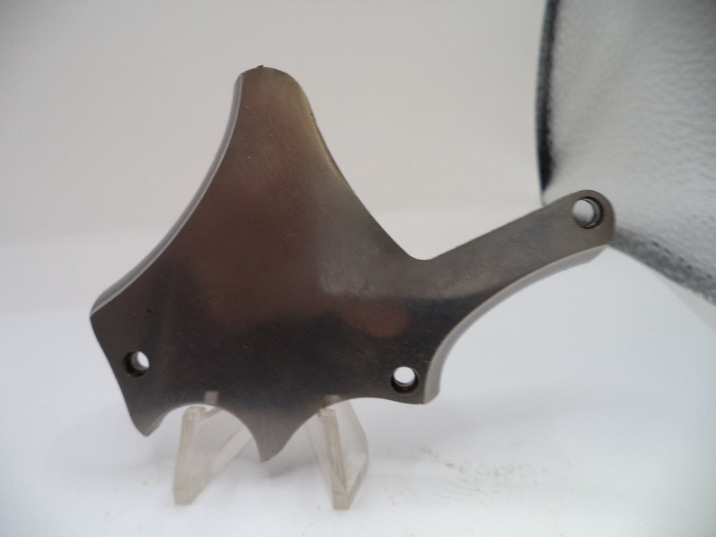 Metallic object on a stand against a neutral background