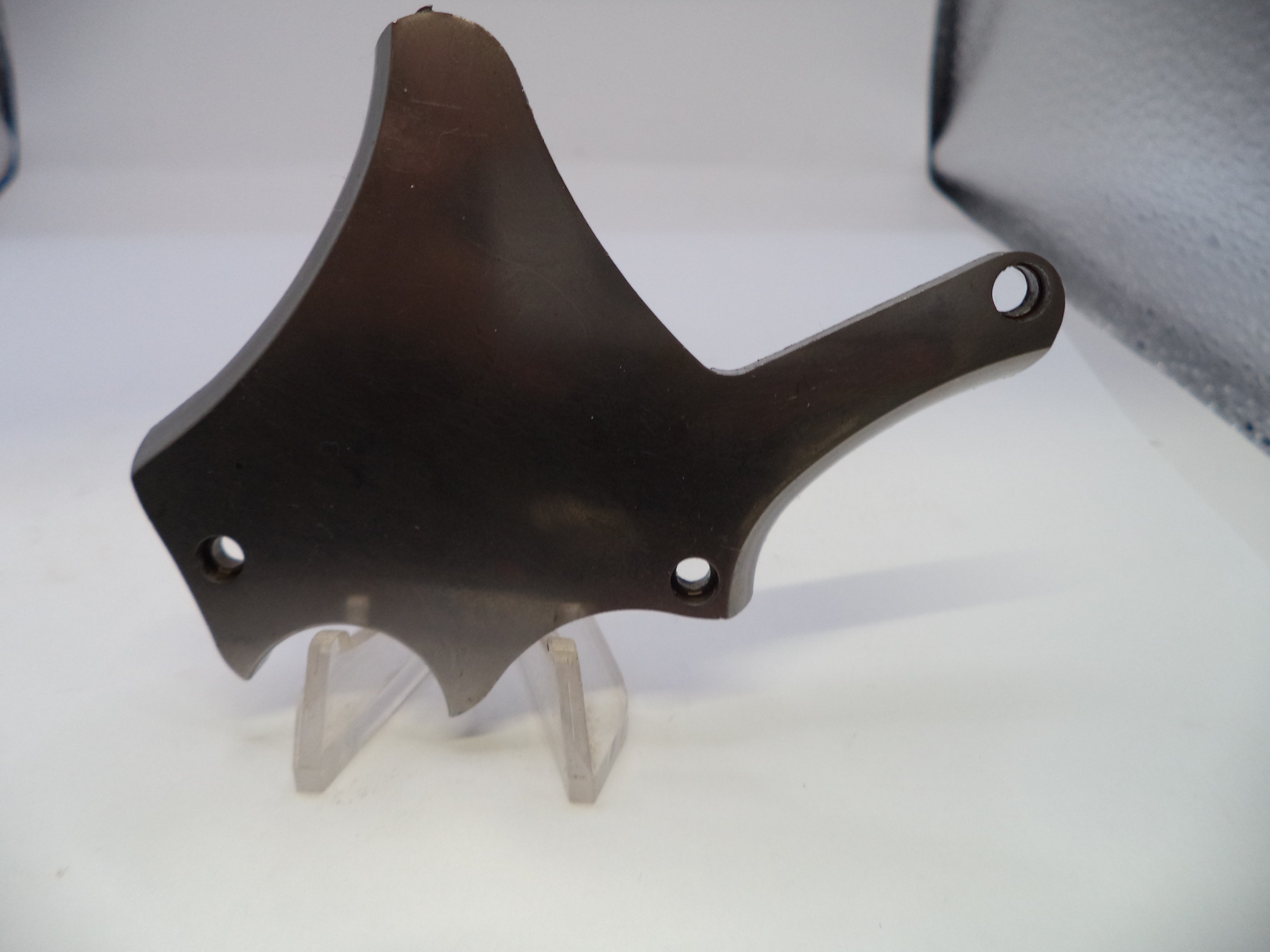 Black metal bracket on a stand against a light gray background