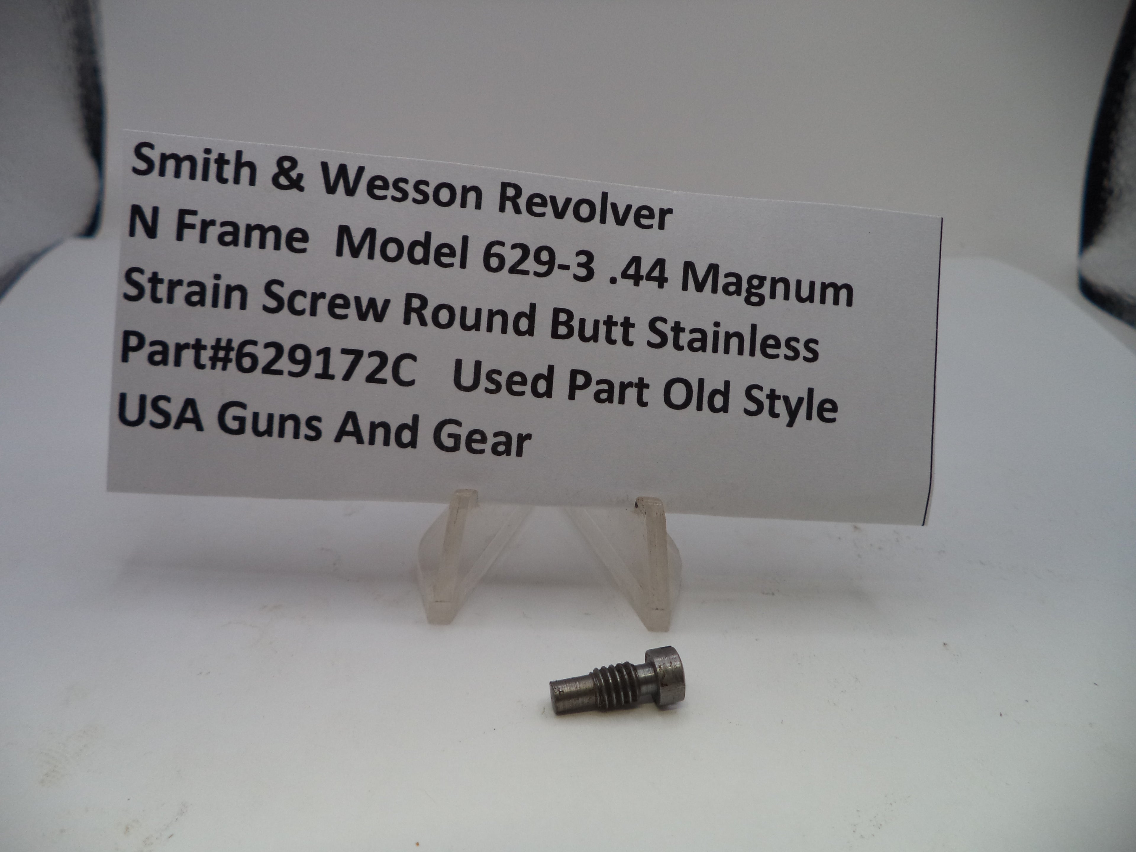 Strain screw with a label detailing specifications on a white background