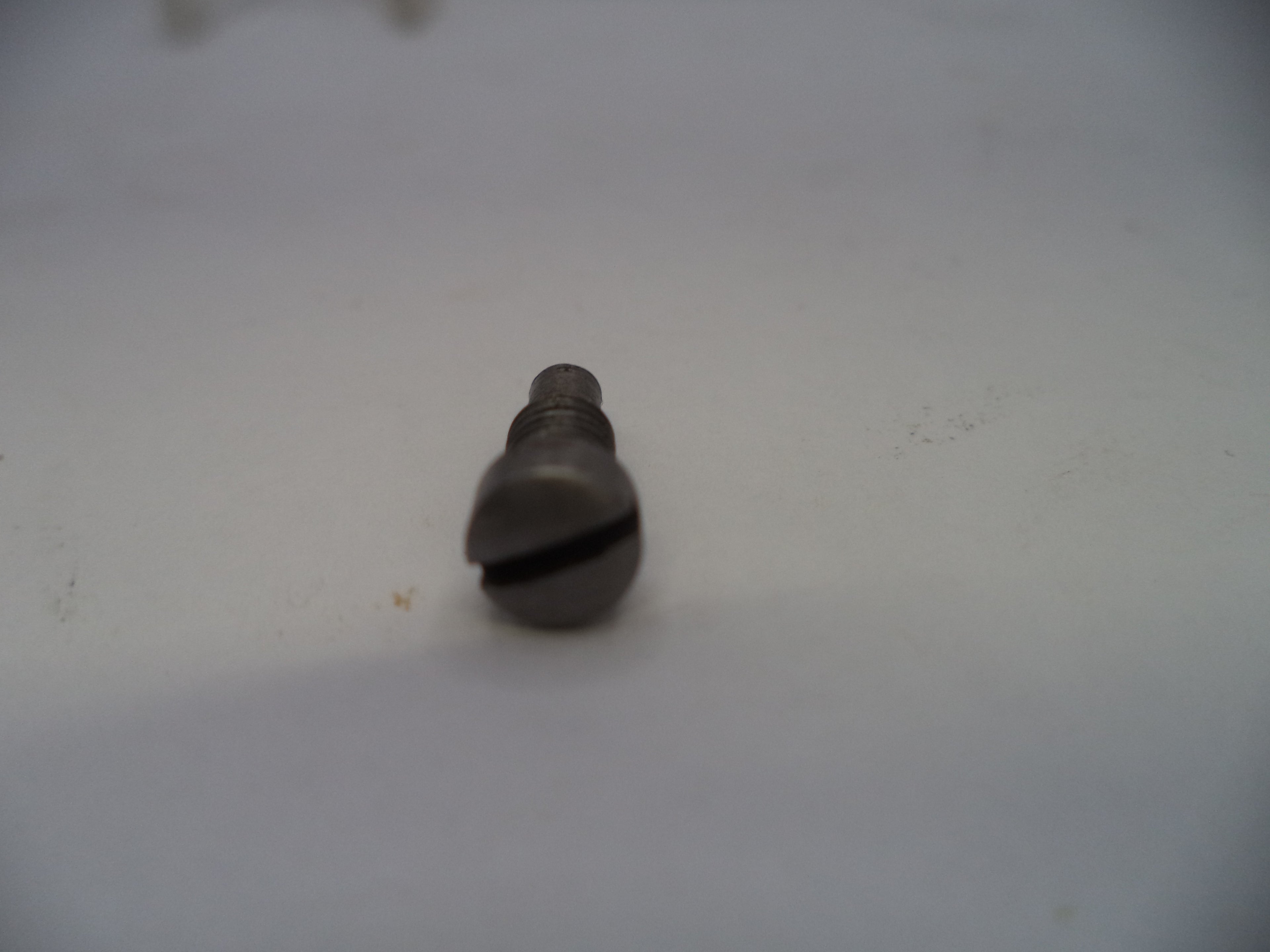 Metallic object on a white surface