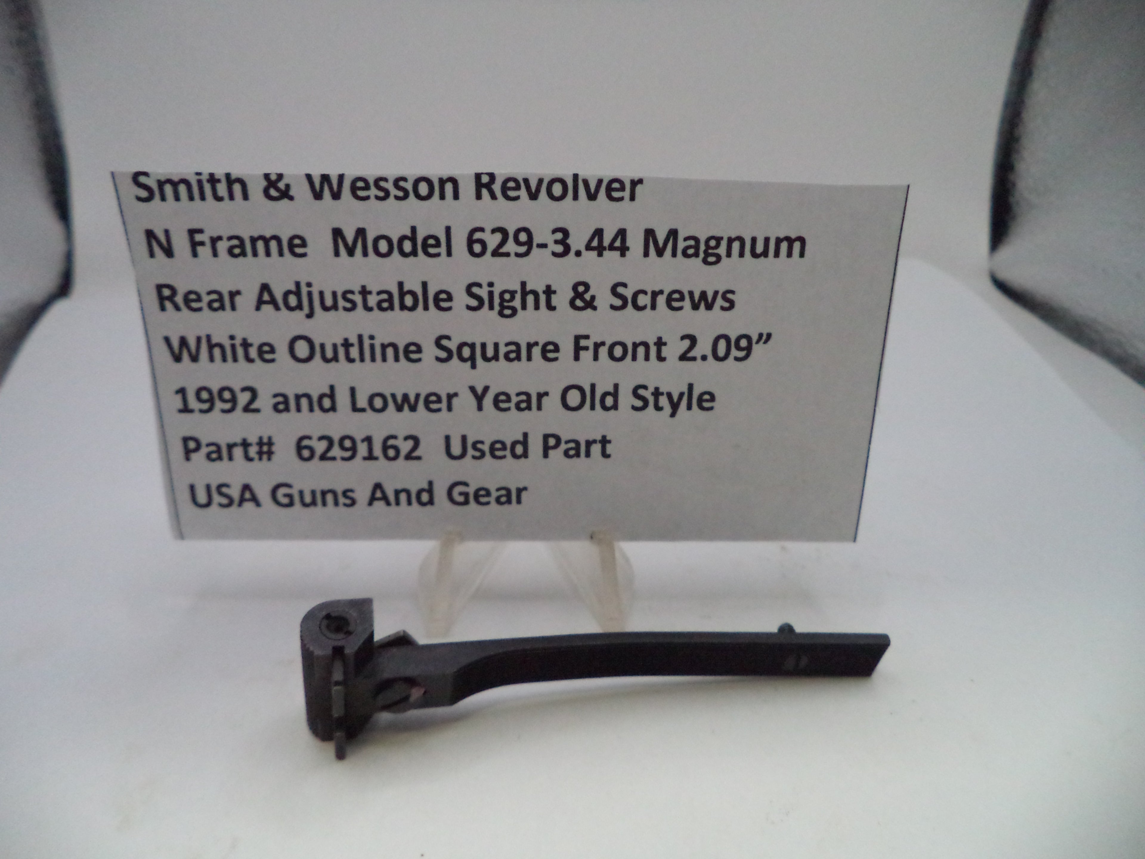 Smith & Wesson revolver part with descriptive card on a white background