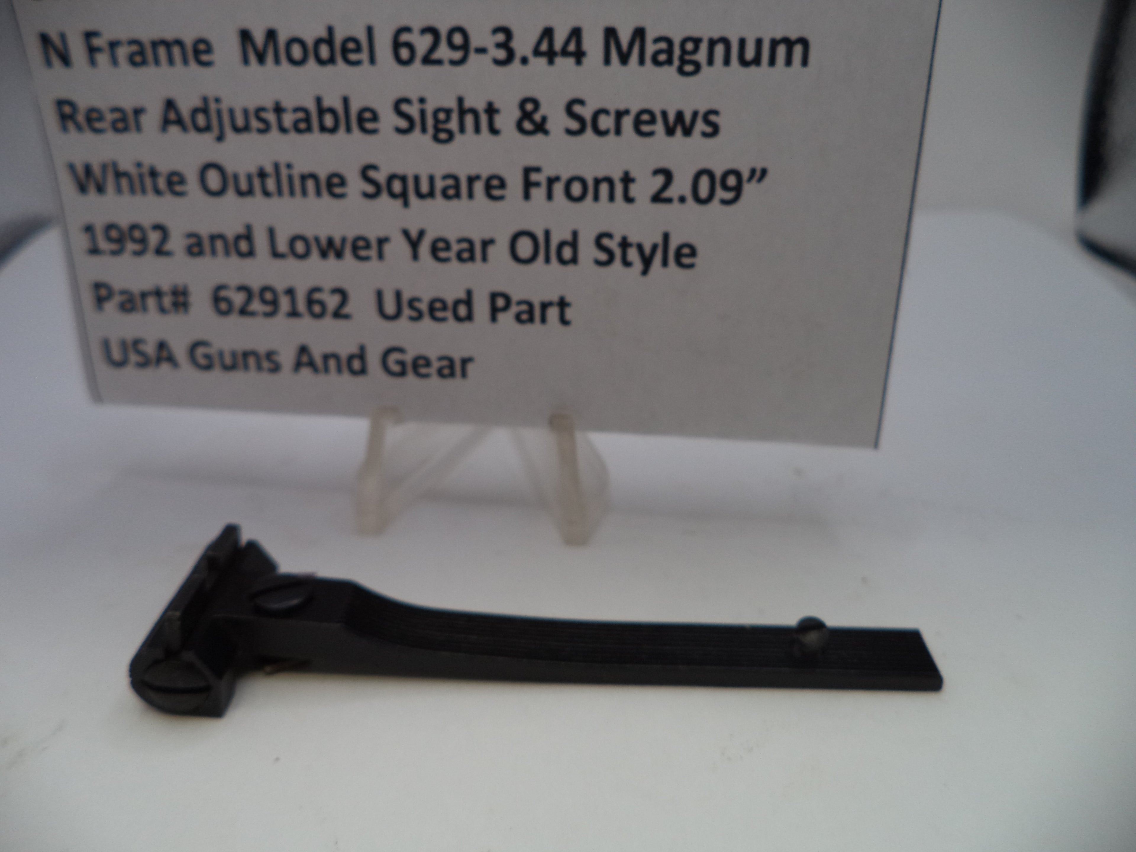 Black adjustable sight with descriptive text card on a white background