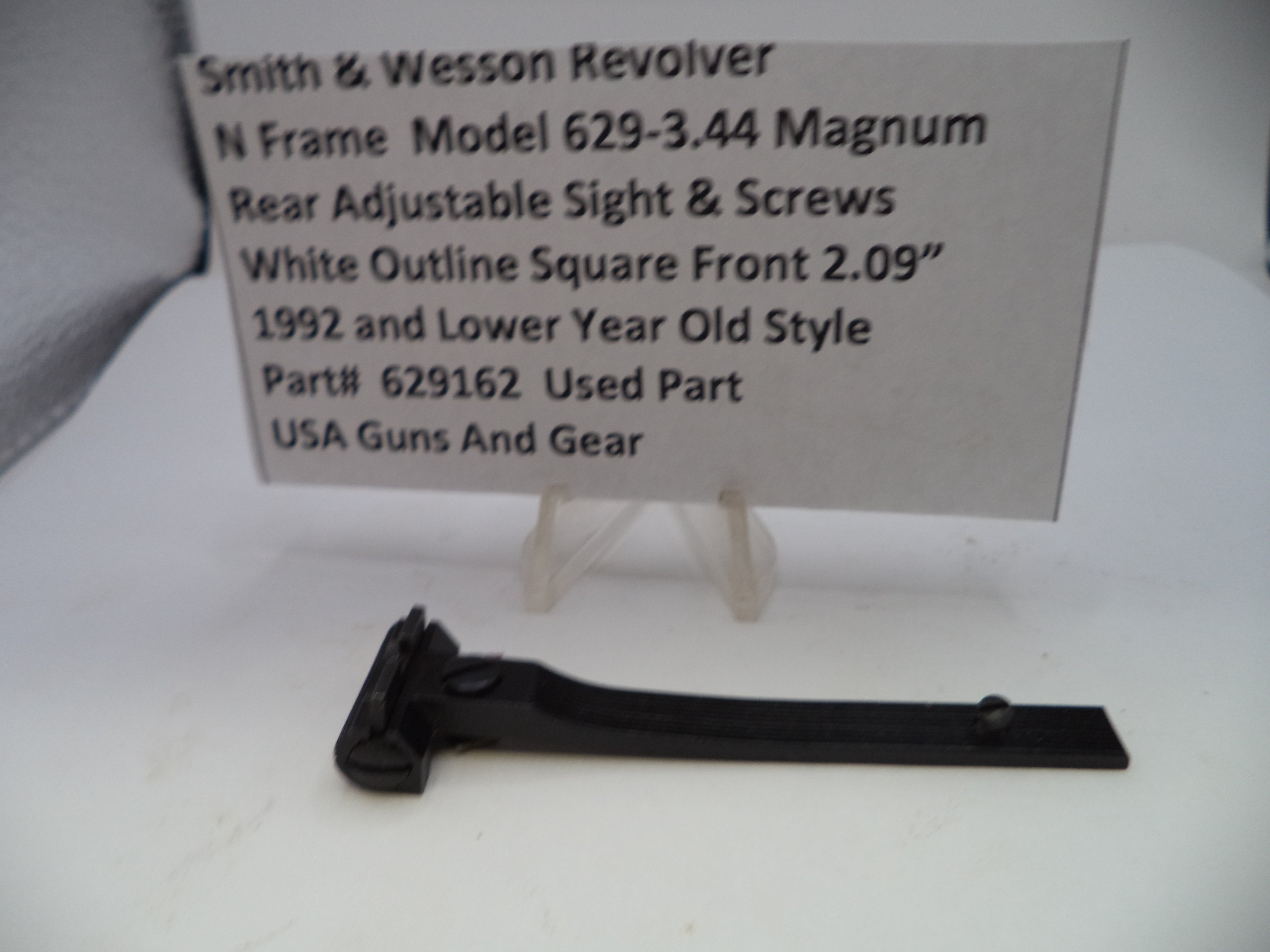 Smith & Wesson revolver part with descriptive card on a white background